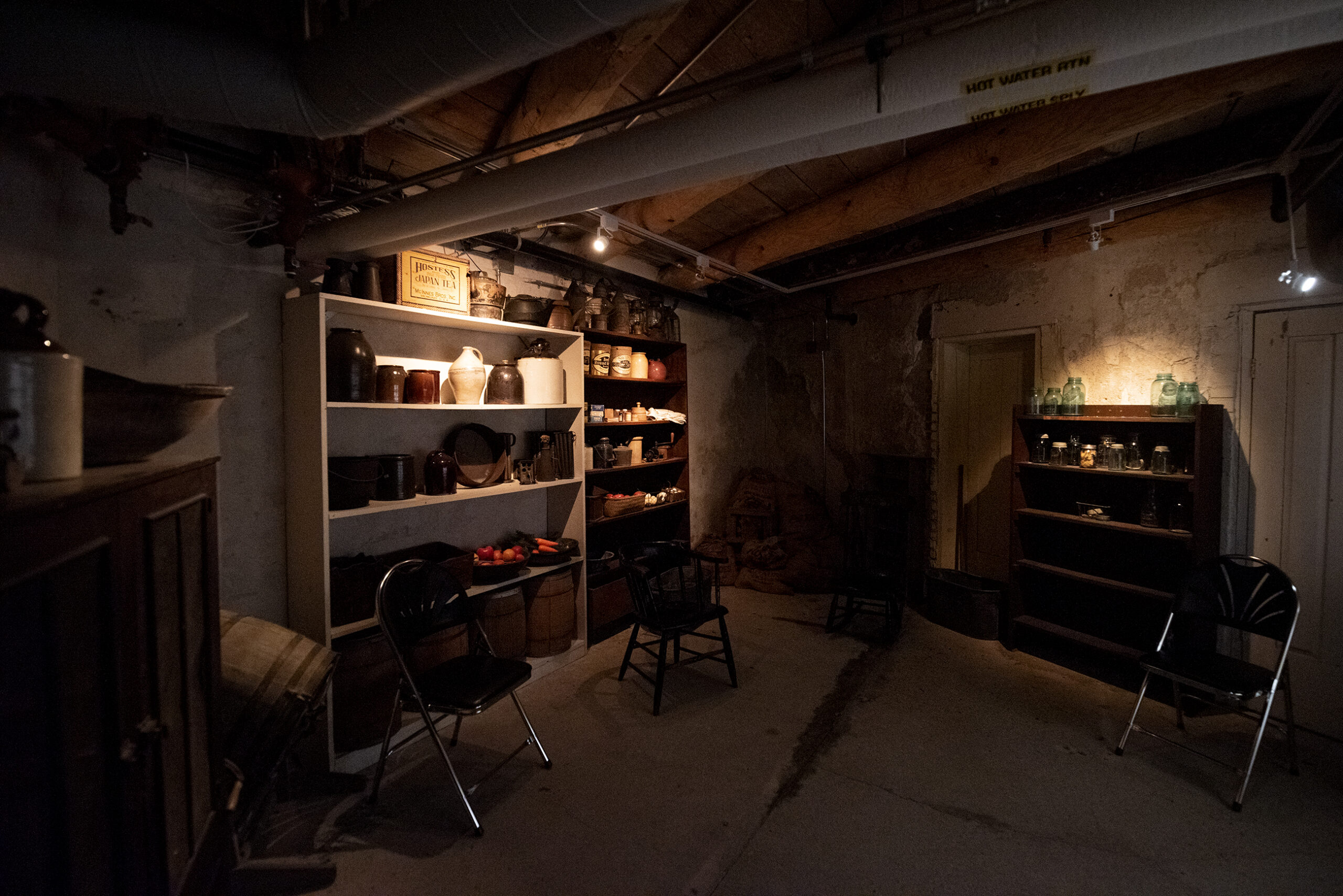 A dark room with items on shelves.