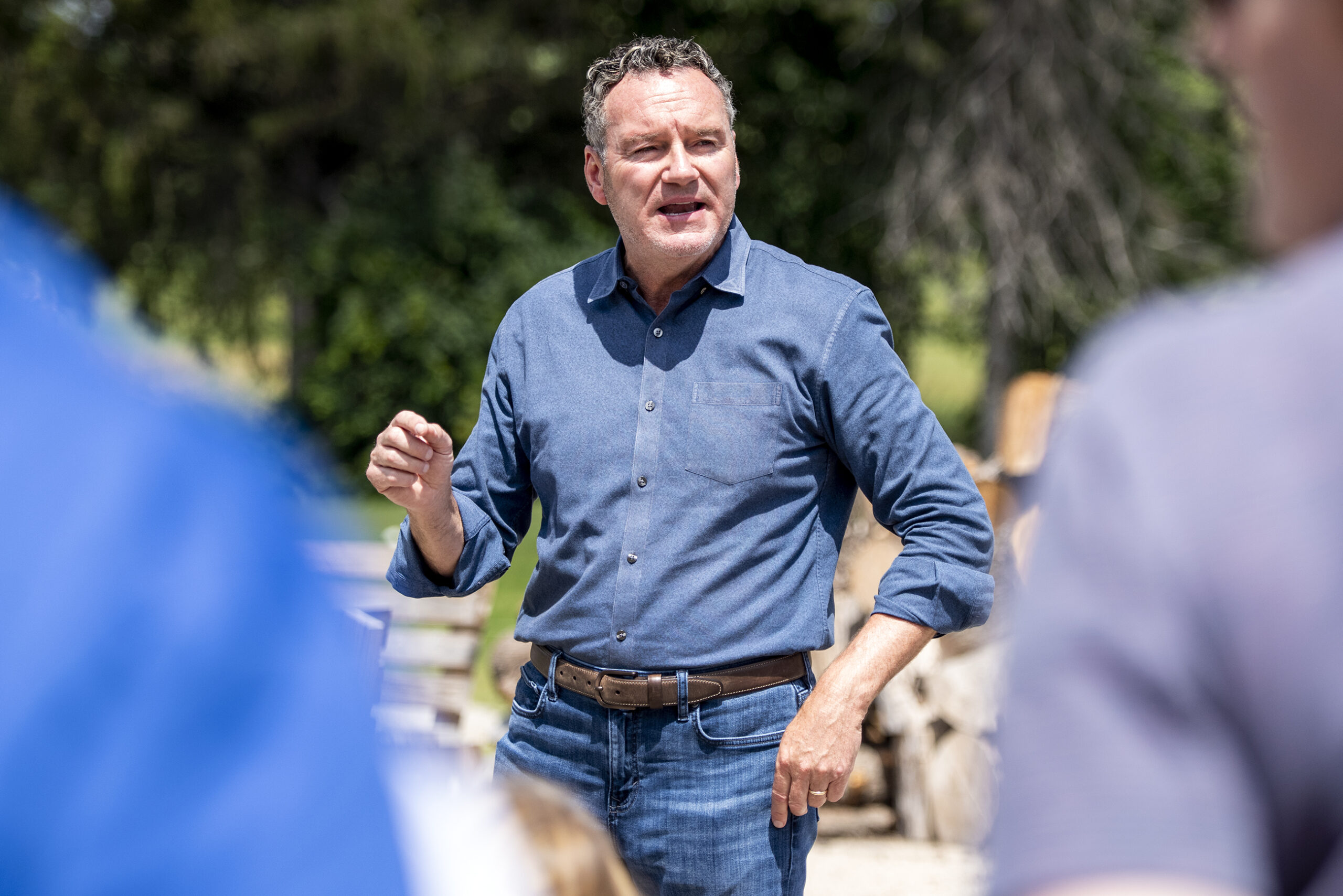 Tim Michels is seen through a group of supporters as he speaks.