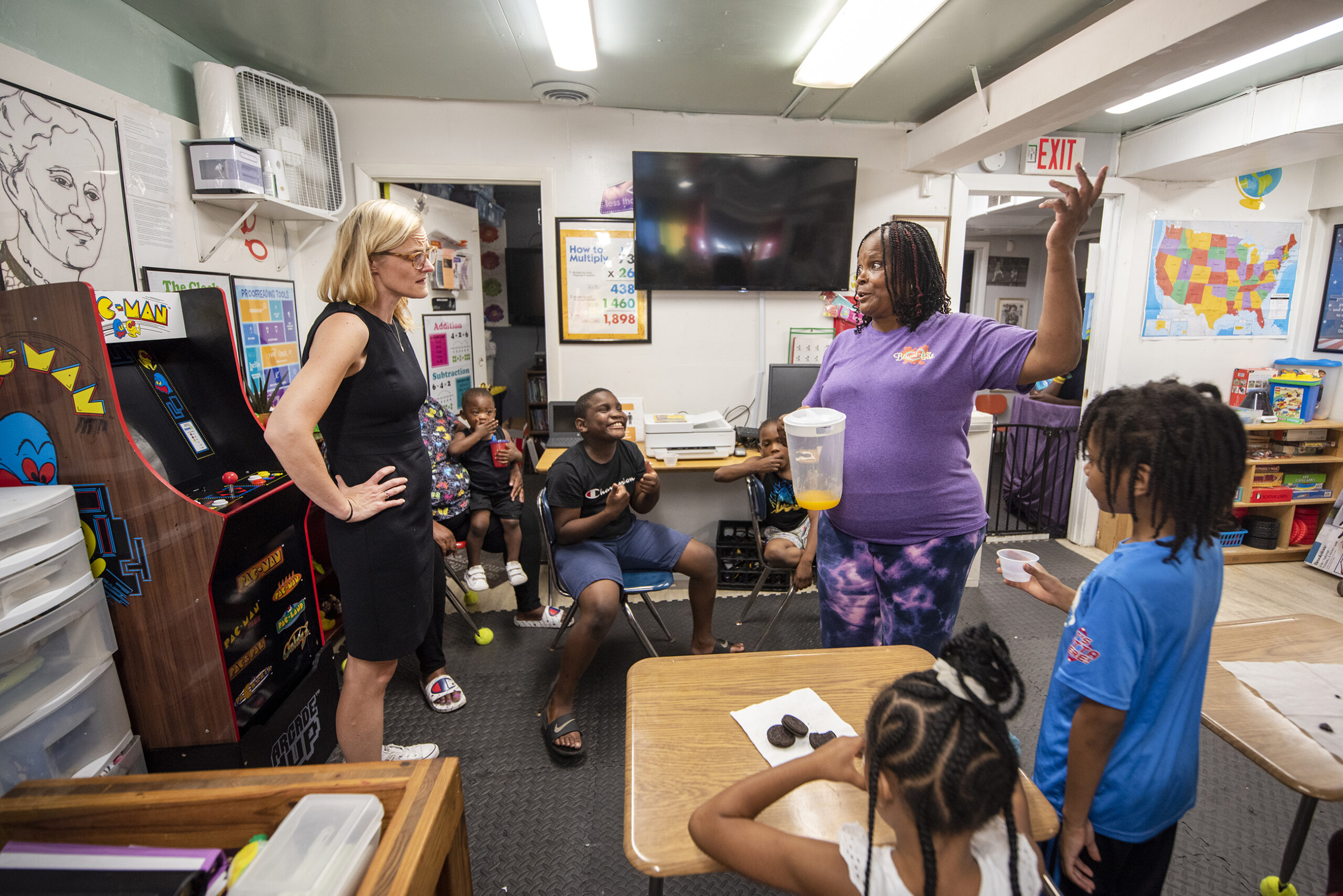 Sarah Godlewski speaks to the owner of the child care center in the front of a classroom.