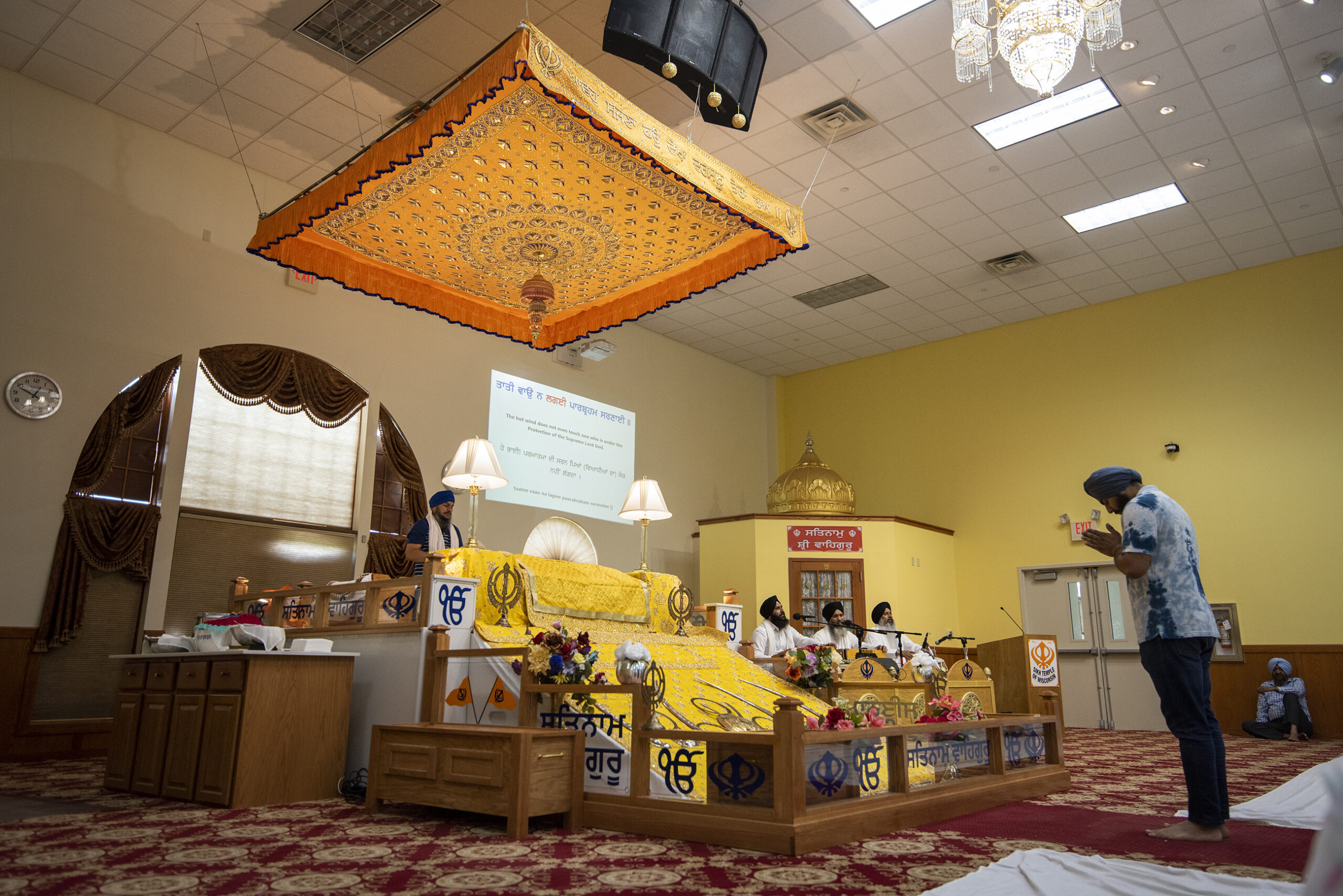 A man bows as he reaches the front of the prayer hall.