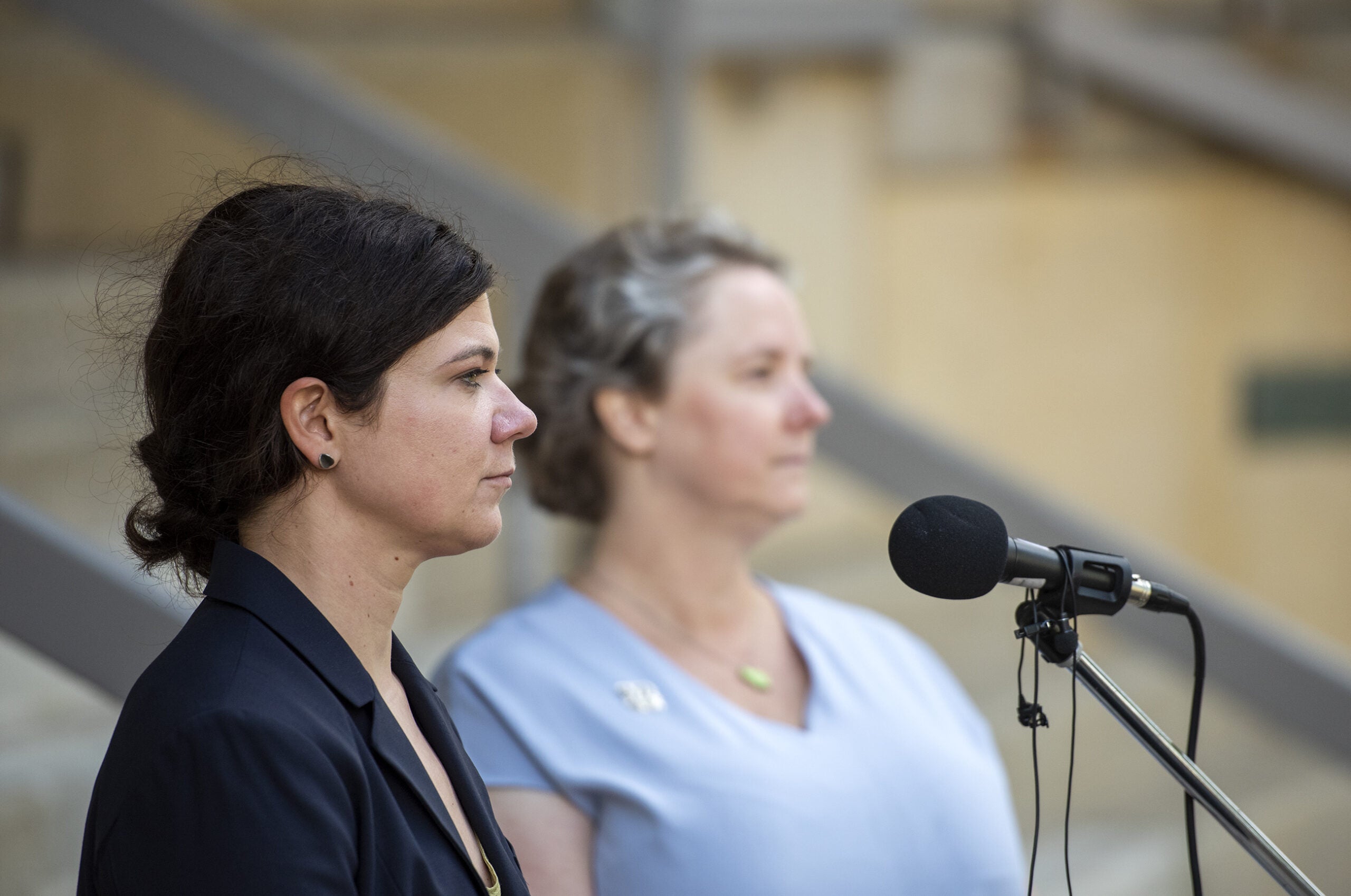 Mel Barnes and Stay Rhodes-Conway stand outside at a press conference.