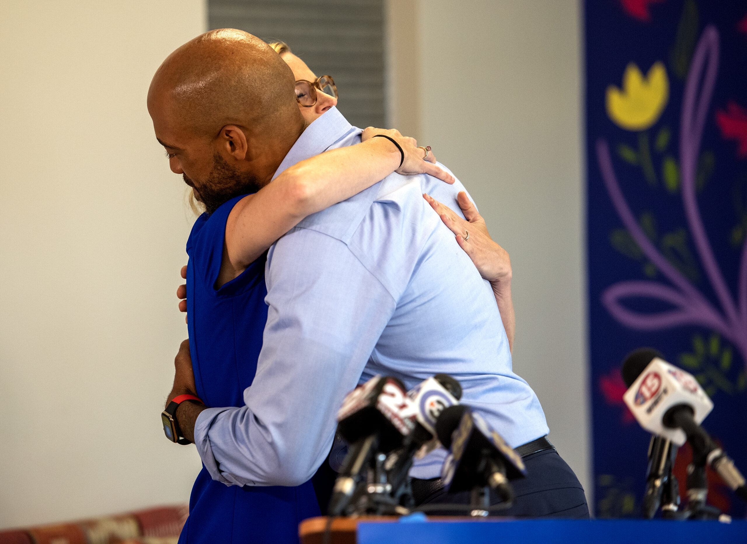 Sarah Godlewski and Mandela Barnes hug during a press conference.