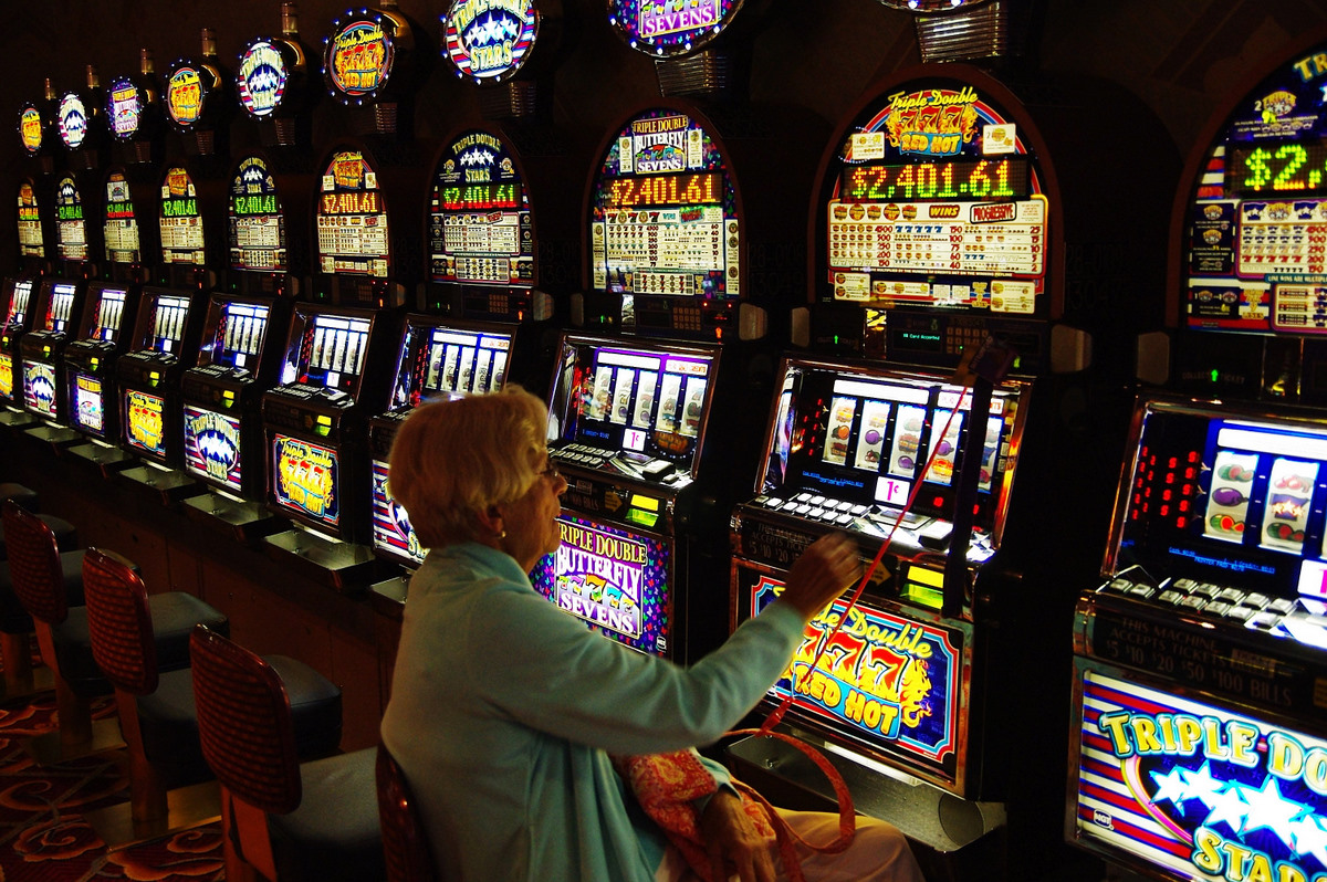 A lady playing the slots.