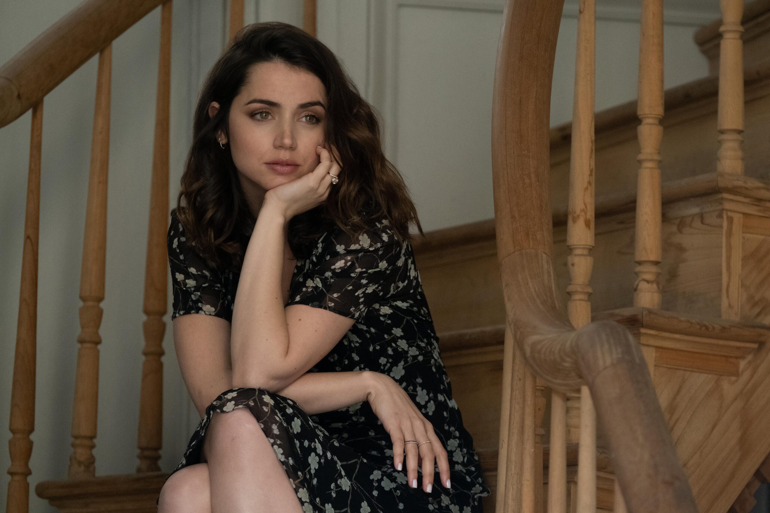 Ana de Armas sitting on staircase in scene from "Deep Water"