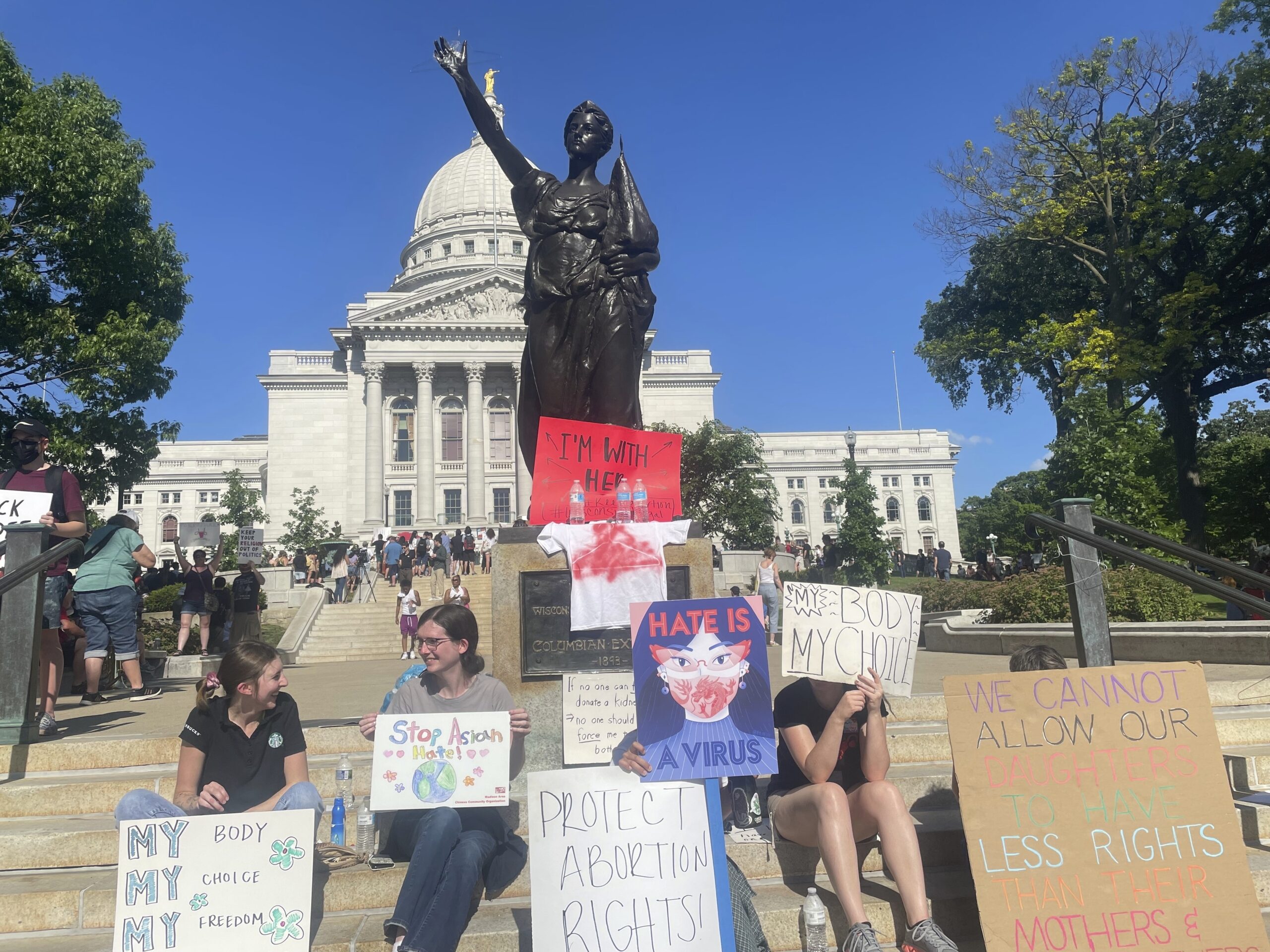 Protesters gather outside the state Capitol building in Madison, Wis.