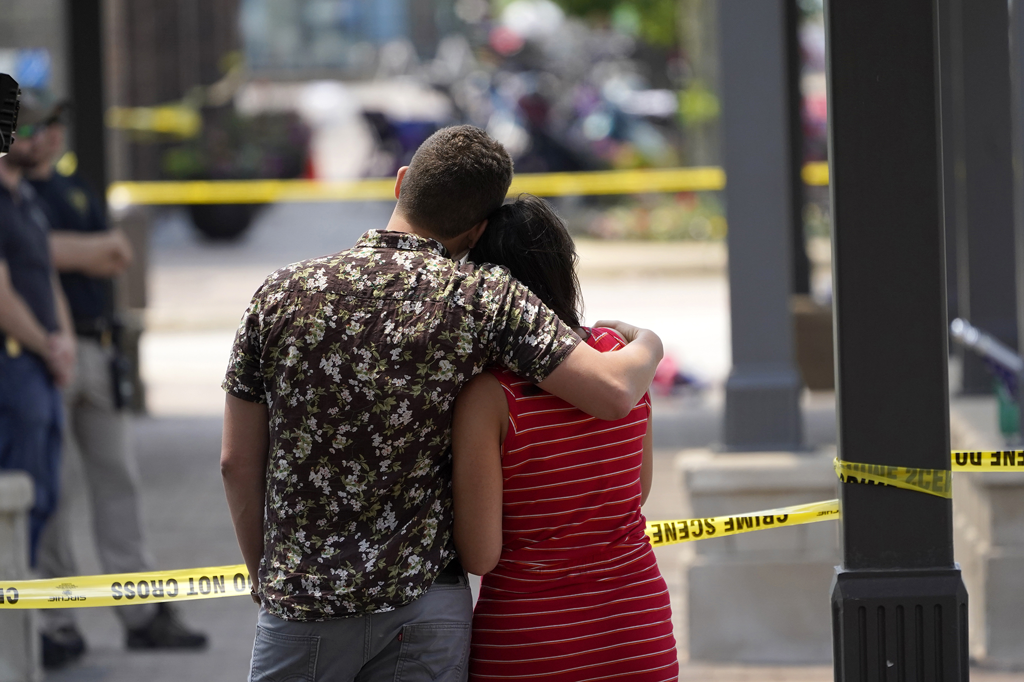 Brooke and Matt Strauss look toward the scene of the mass shooting in downtown Highland Park