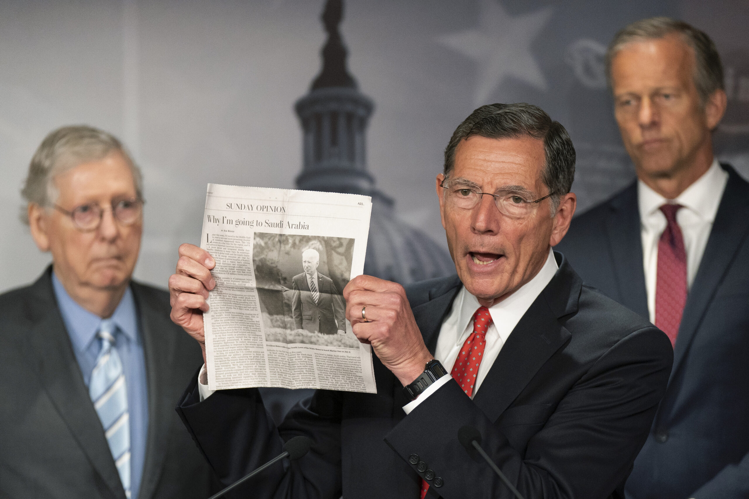 U.S. senator holding up a newspaper clip