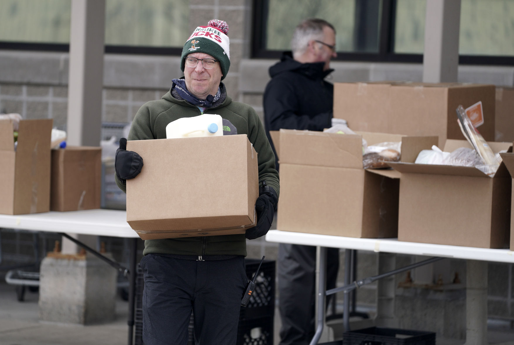 Chris Kane, director of client services at St. Vincent de Paul, helps with curbside delivery at the nonprofit’s food pantry