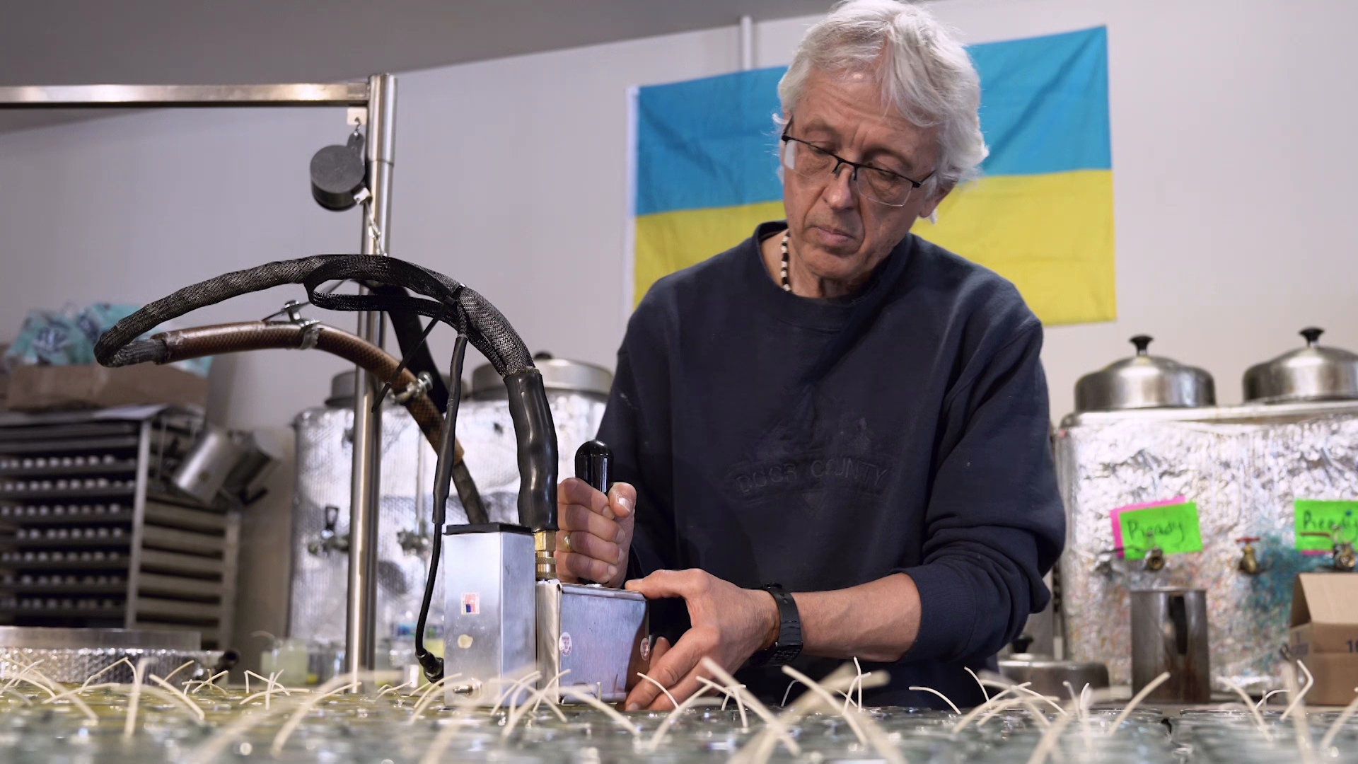 A man manufactures candles at a candle shop