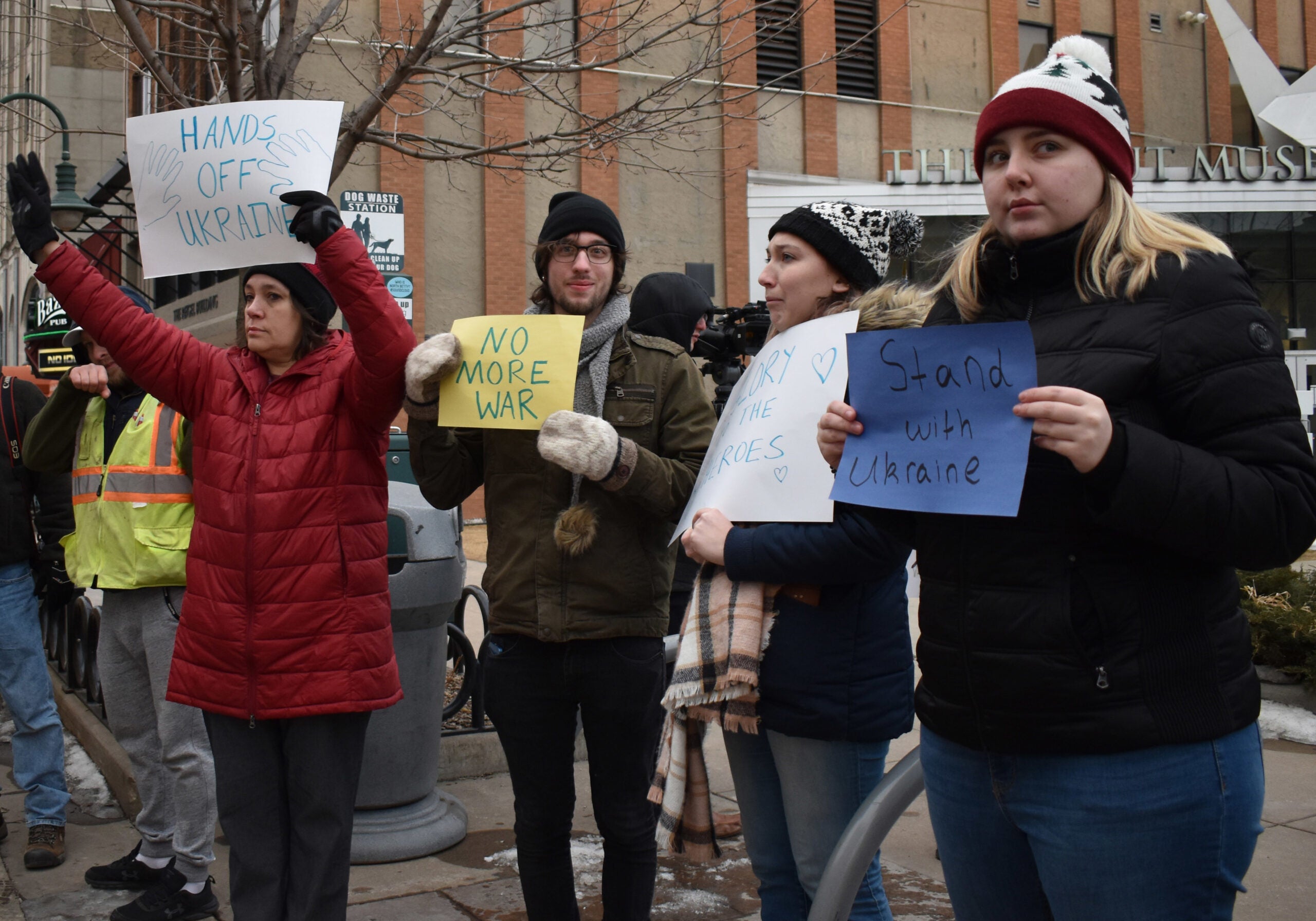 Protesters display antiwar signs at a rally and donation event for Ukraine at Houdini Plaza in Appleton