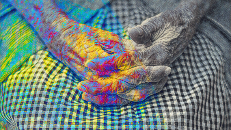 older person's hands lightly colored in psychedelic colors