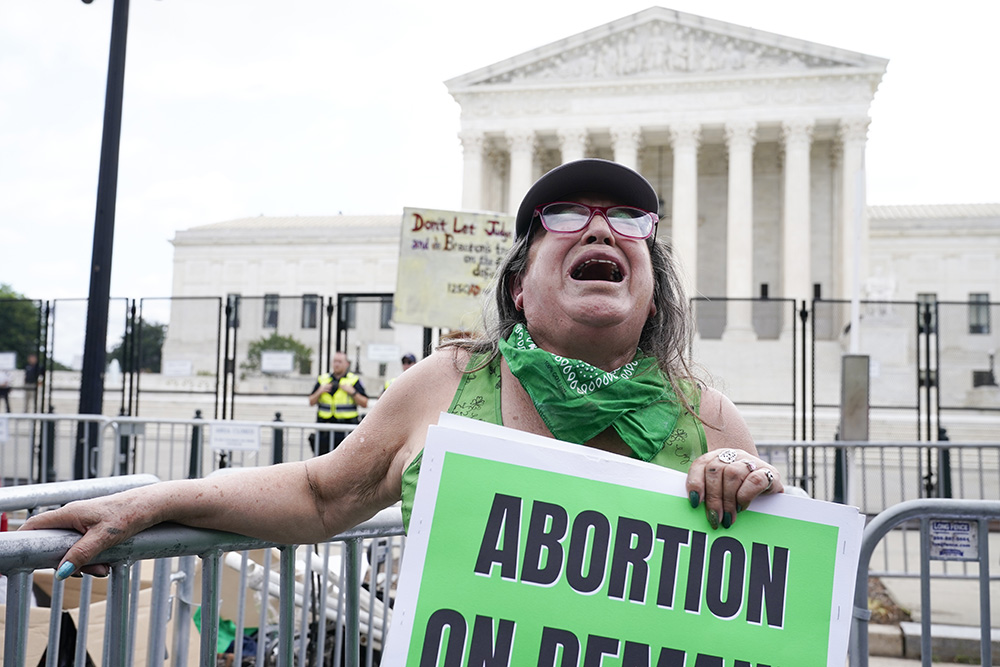 An abortion-rights activist reacts outside the Supreme Court in Washington