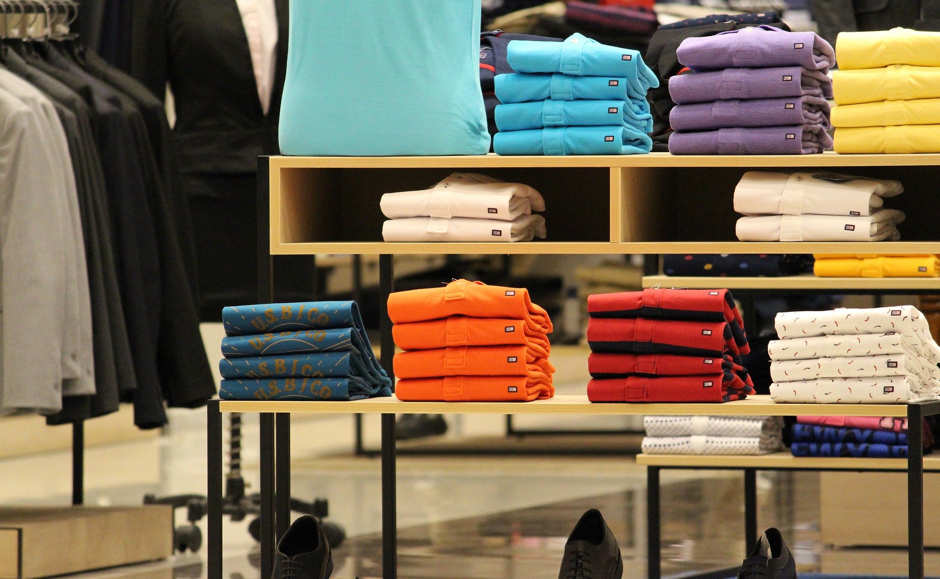 Stacks of tee shirts in a store display.