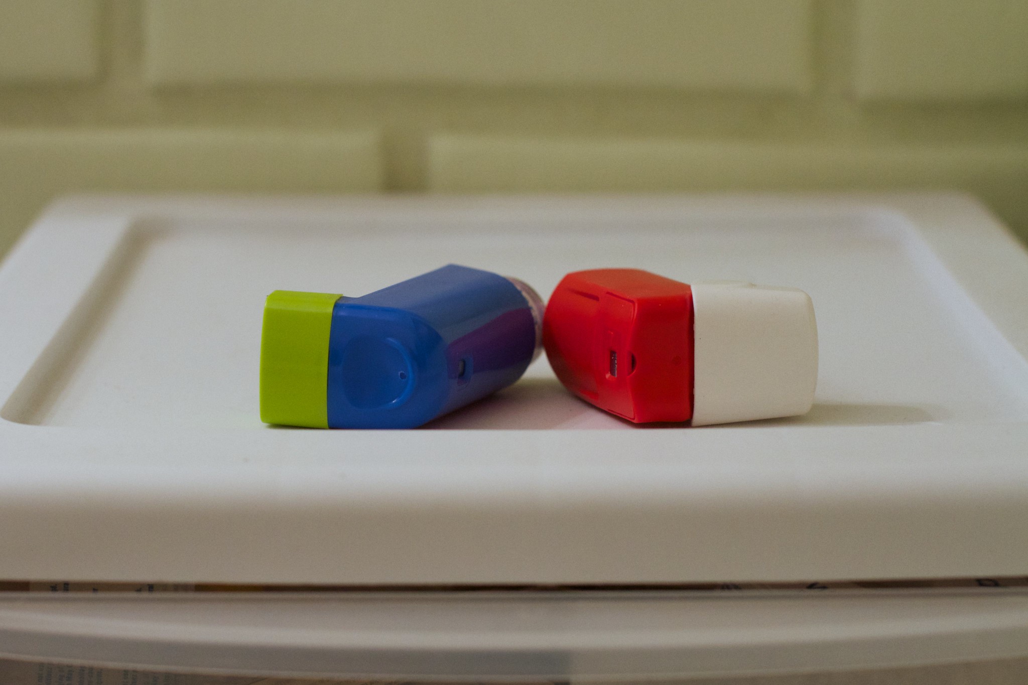 Two inhalers sitting on a counter