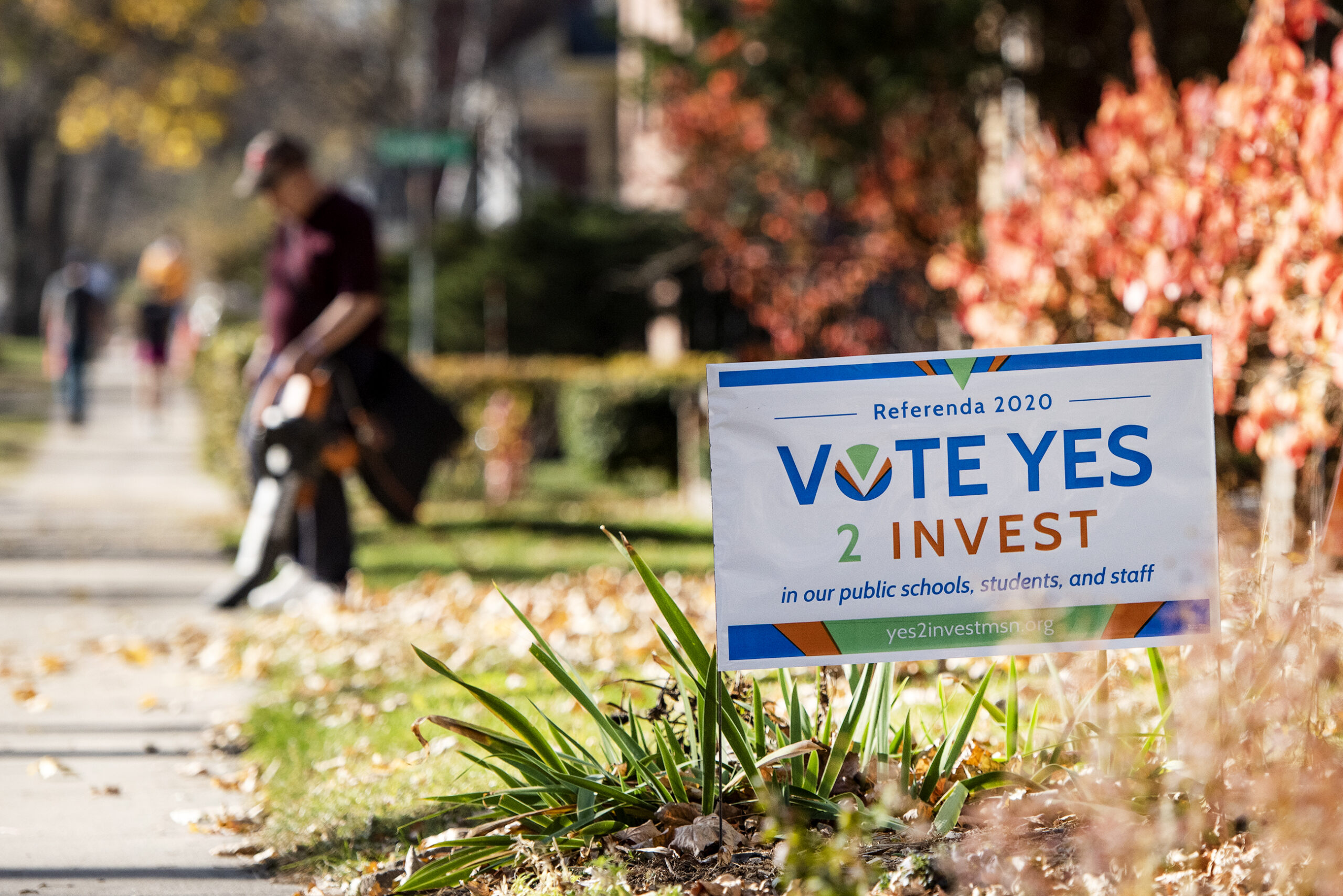 a sign says "Vote Yes 2 Invest"