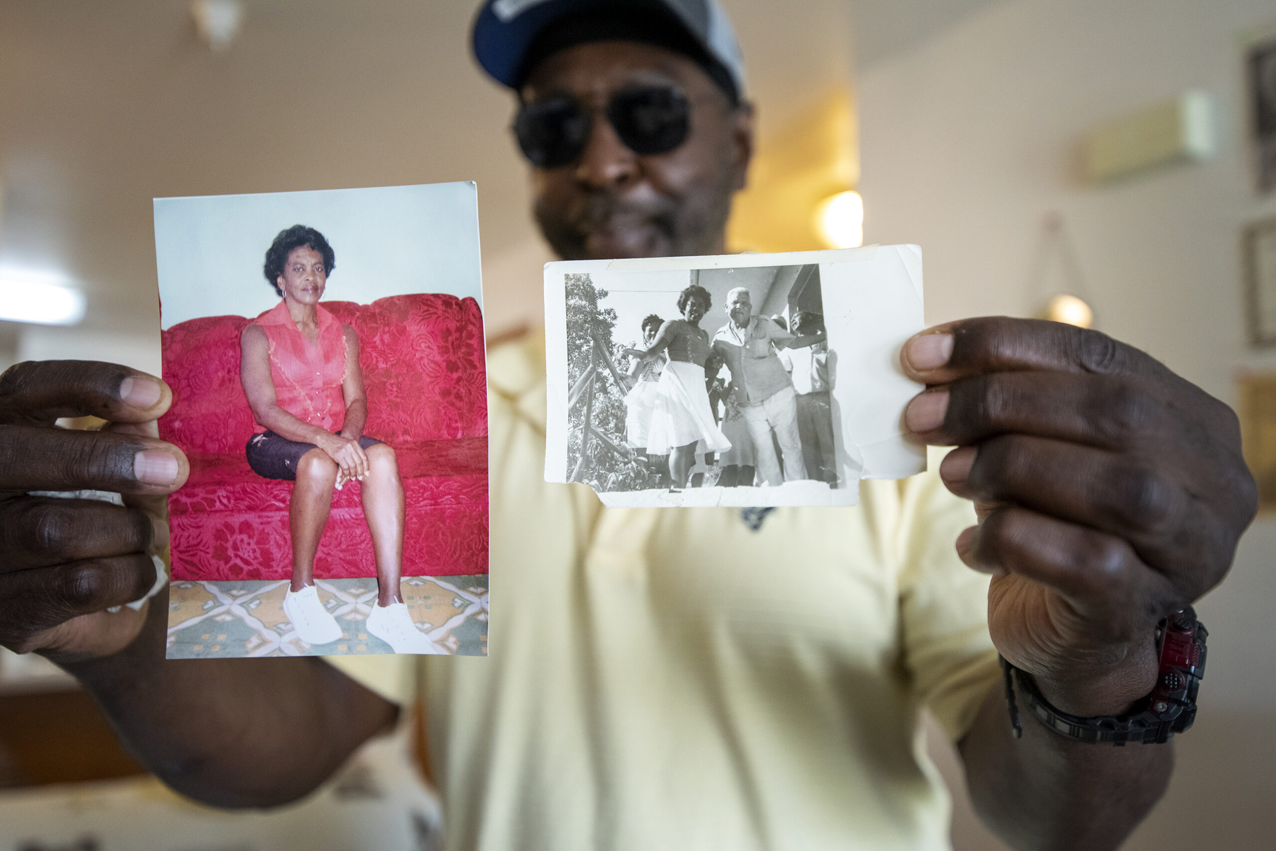 Osvaldo Durruthy holds up a photo of his mother in each hand