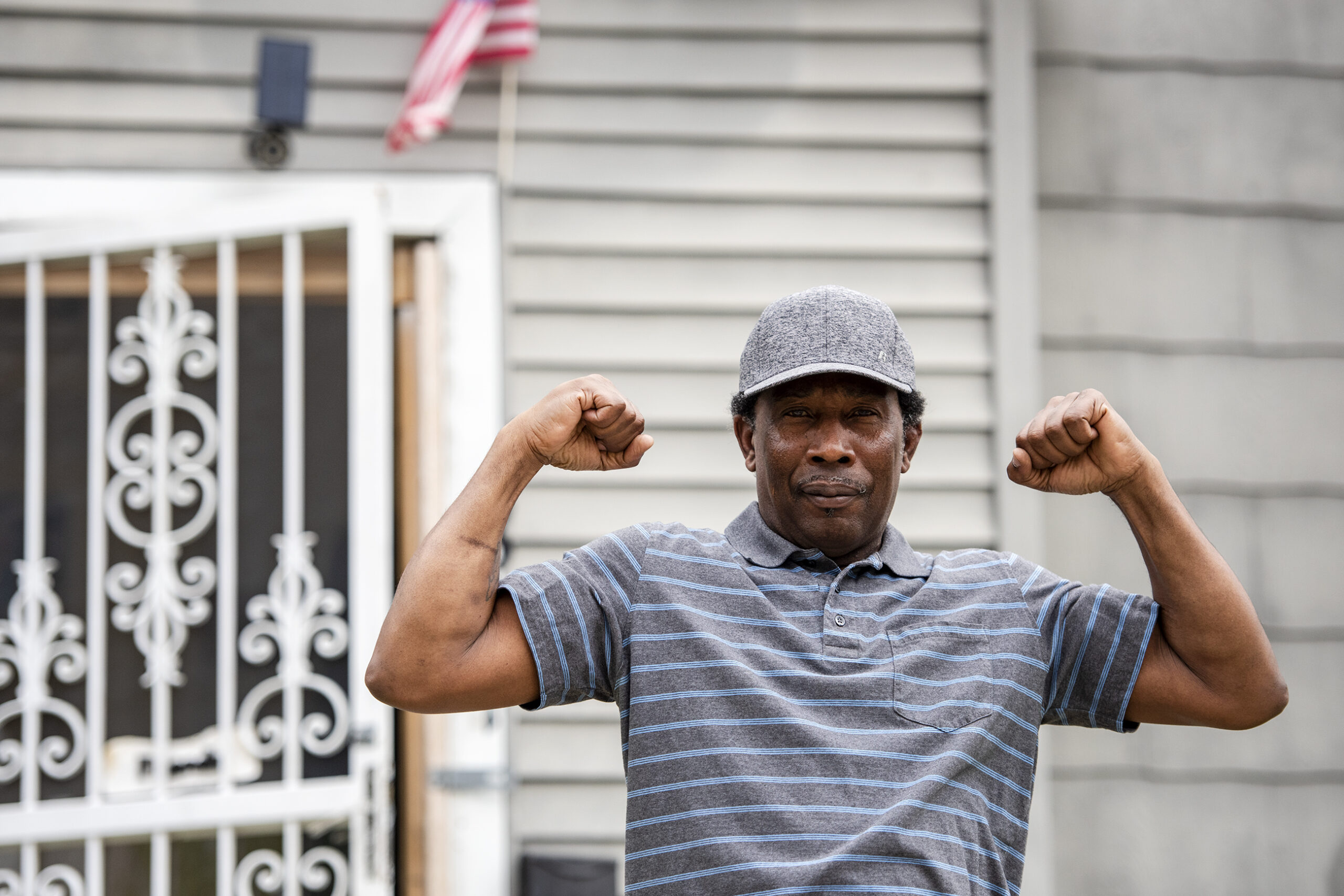 Ernesto Rodriguez poses flexing his arm muscles