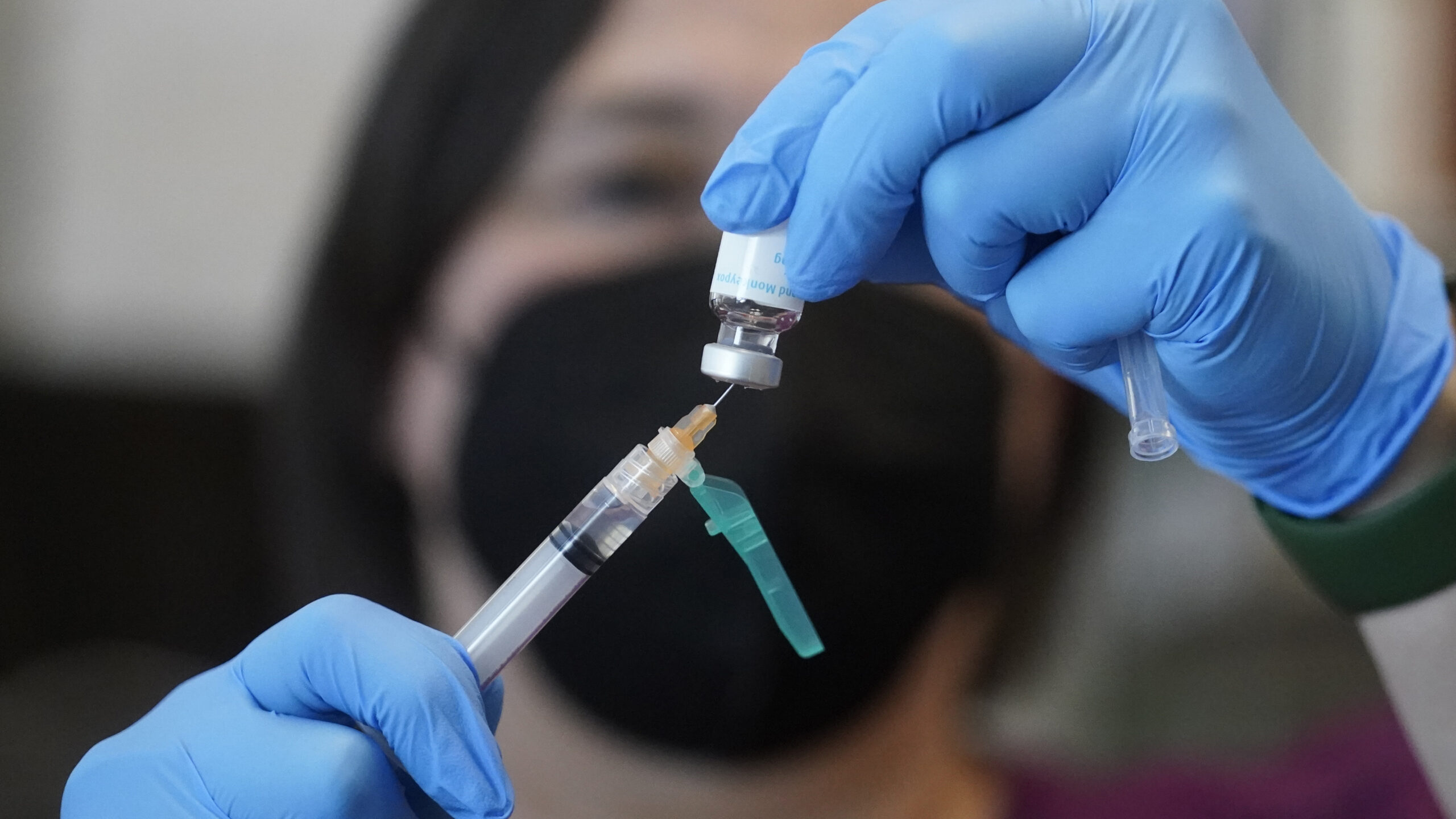 A registered nurse prepares a dose of a Monkeypox vaccine