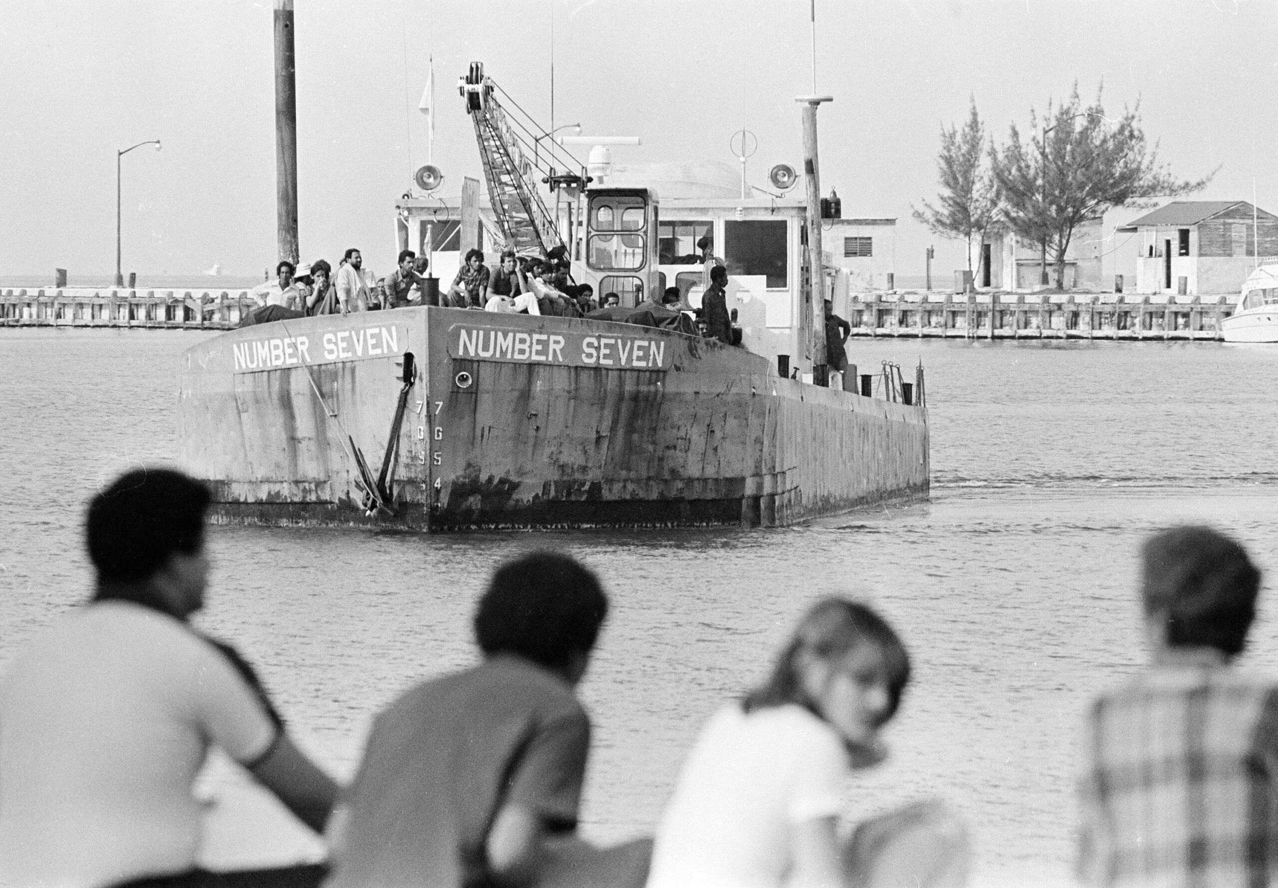 ends and relatives of Cuban refugees line a dock in Key West in April 1980, awaiting a ship