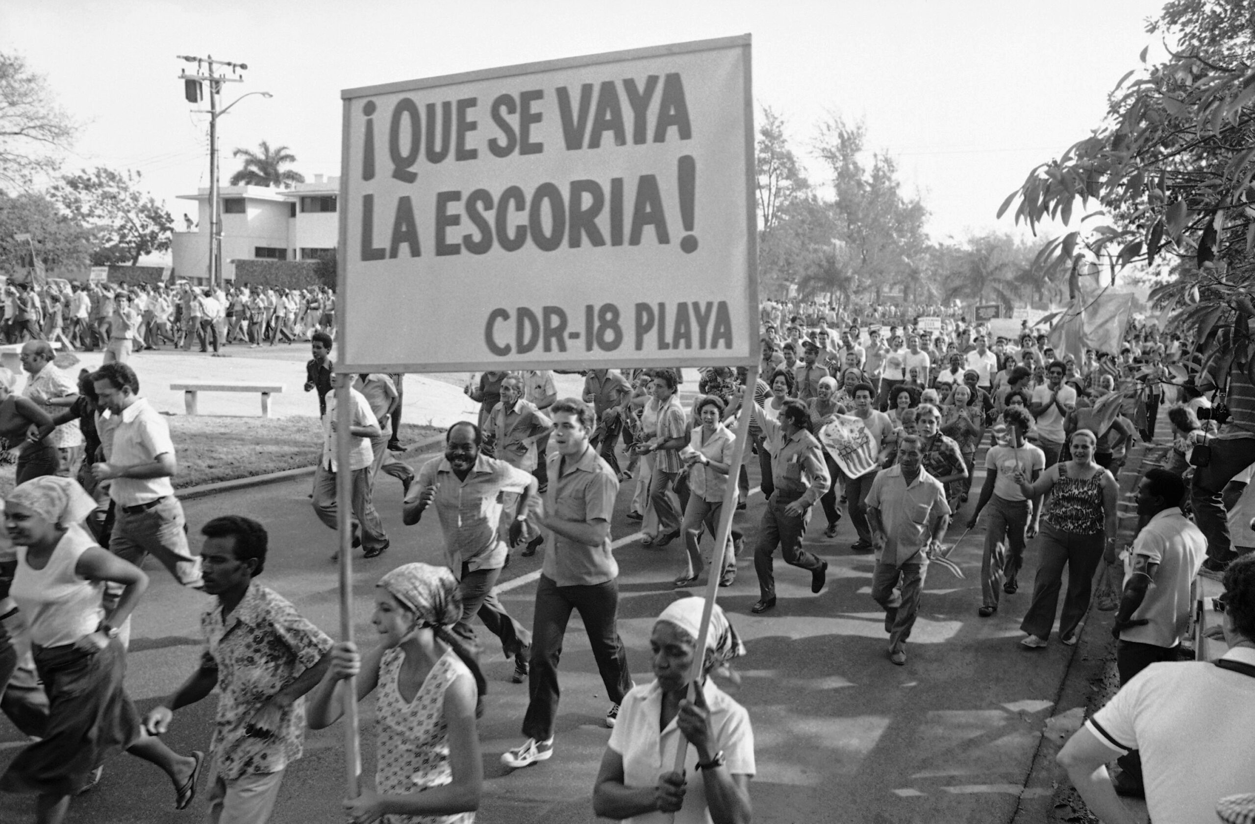 Pro-Castro Cubans carry a banner referring to "la escoria," or undesirables