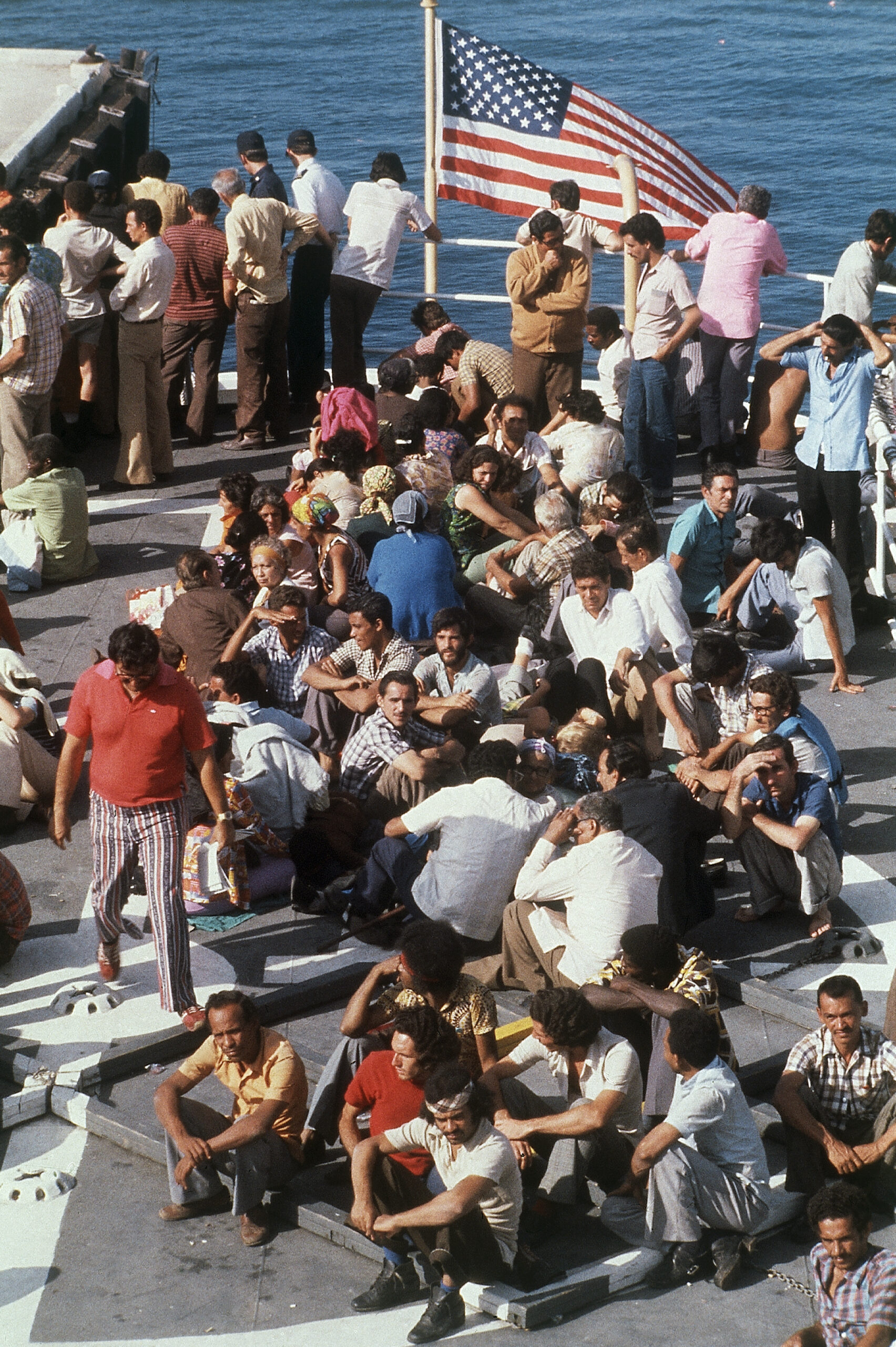 Cuban refugees wait on flight desk in 1980