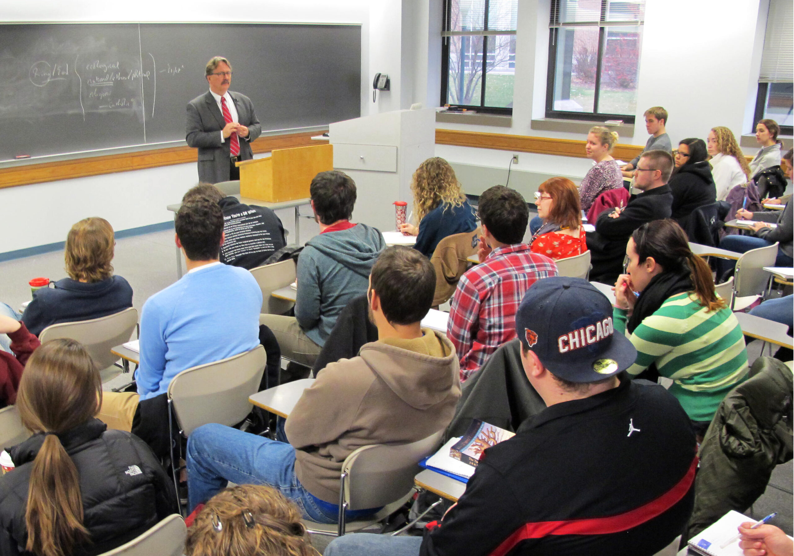 A Marquette University professor lectures to a filled classroom