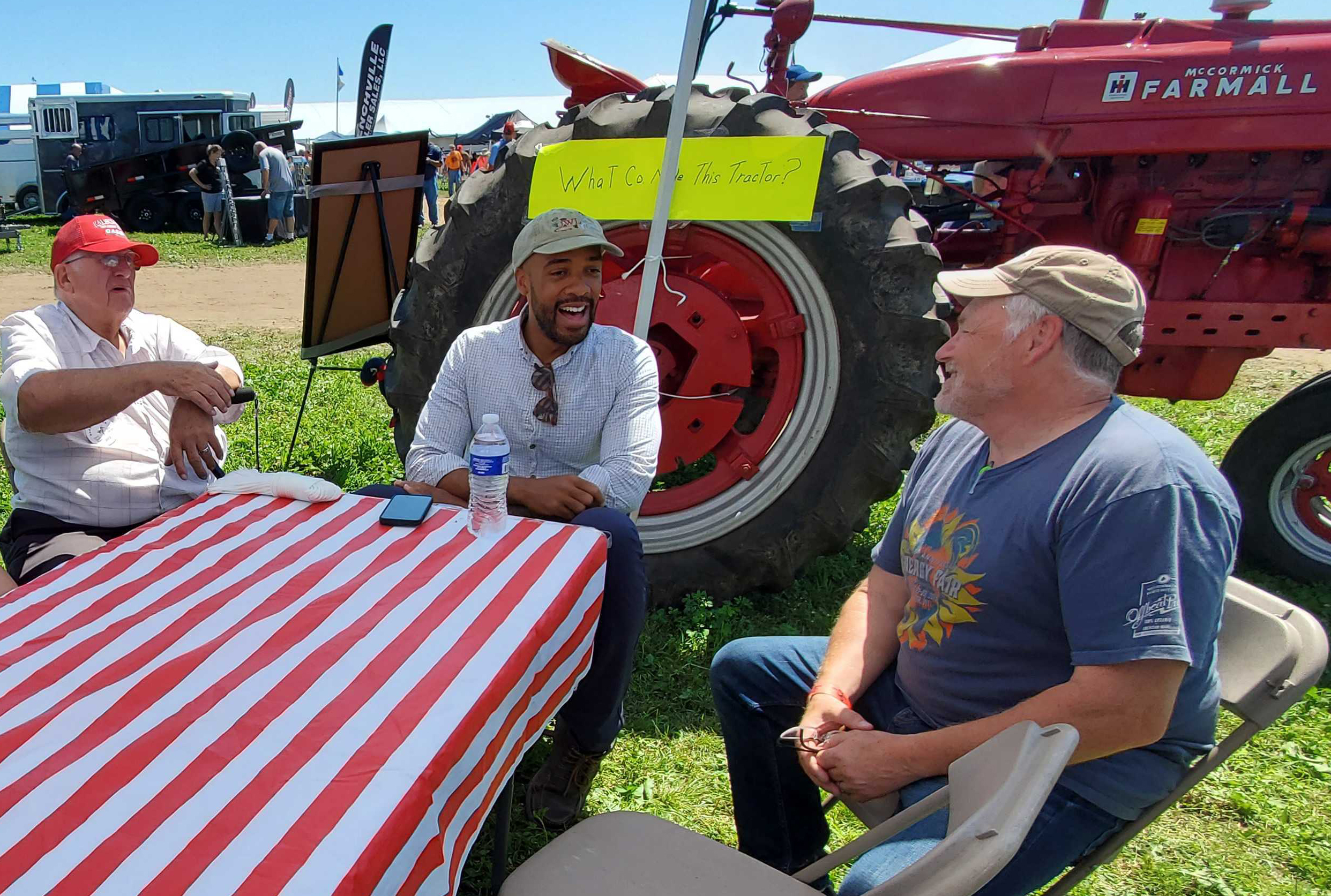 U.S. Senate candidate Lt. Gov. Mandela Barnes, center, speaks with dairy farmer Hans Breitenmoser