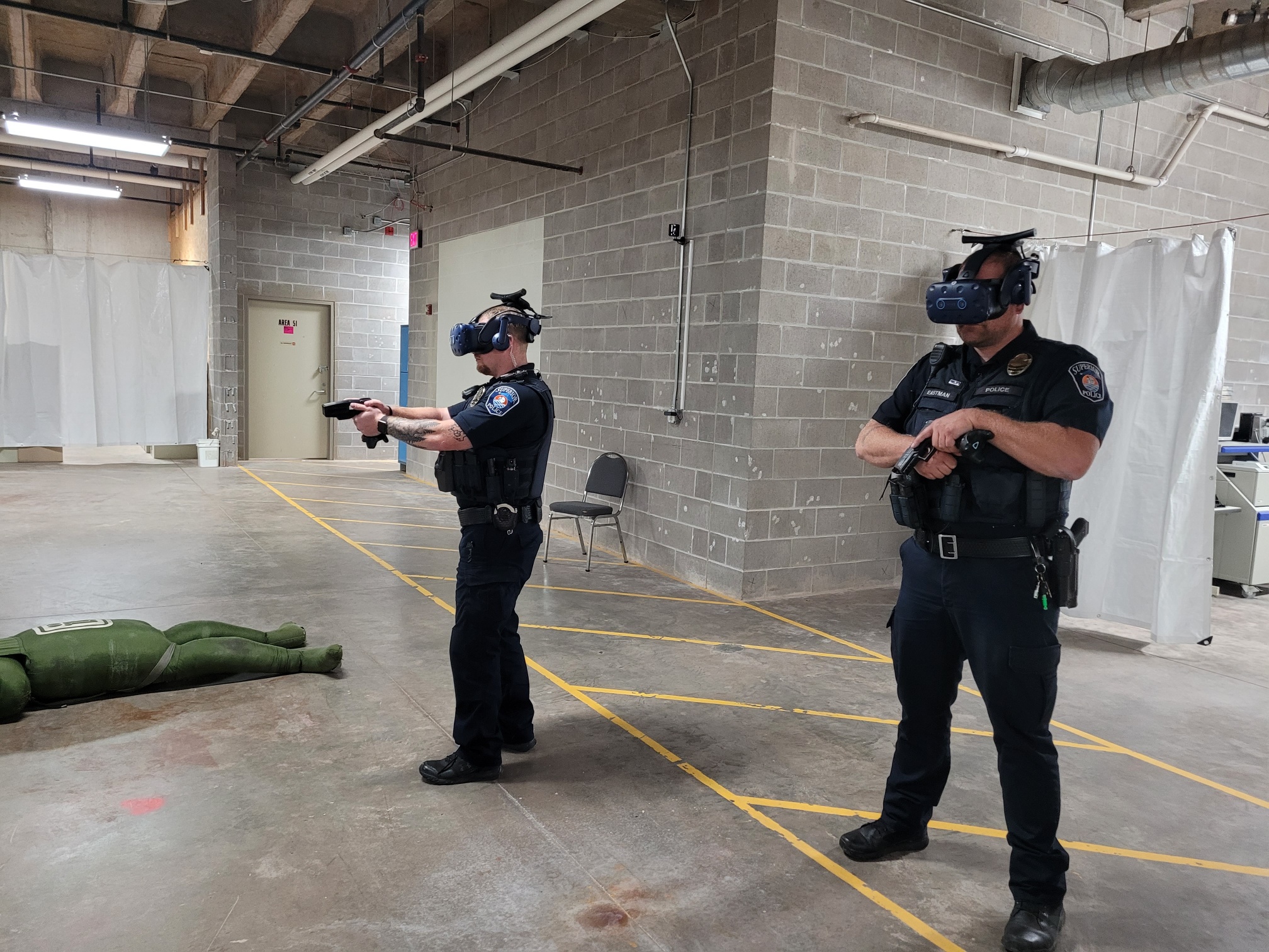 From left, Superior, Wis. police officers Seth Noll and Robert Eastman participate in virtual reality law enforcement training