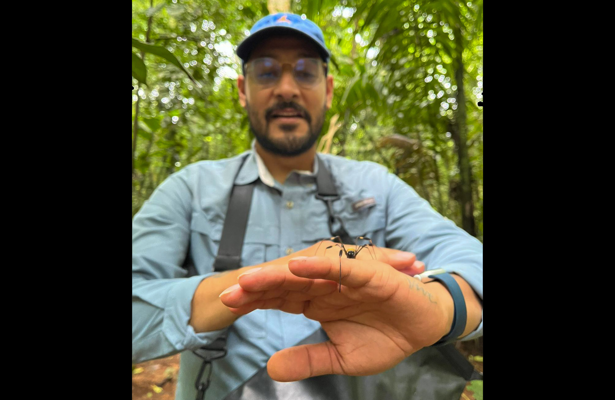 Third-grade teacher Blas Antimo Perez of Milwaukee poses with a spider in the rainforest of Panama.