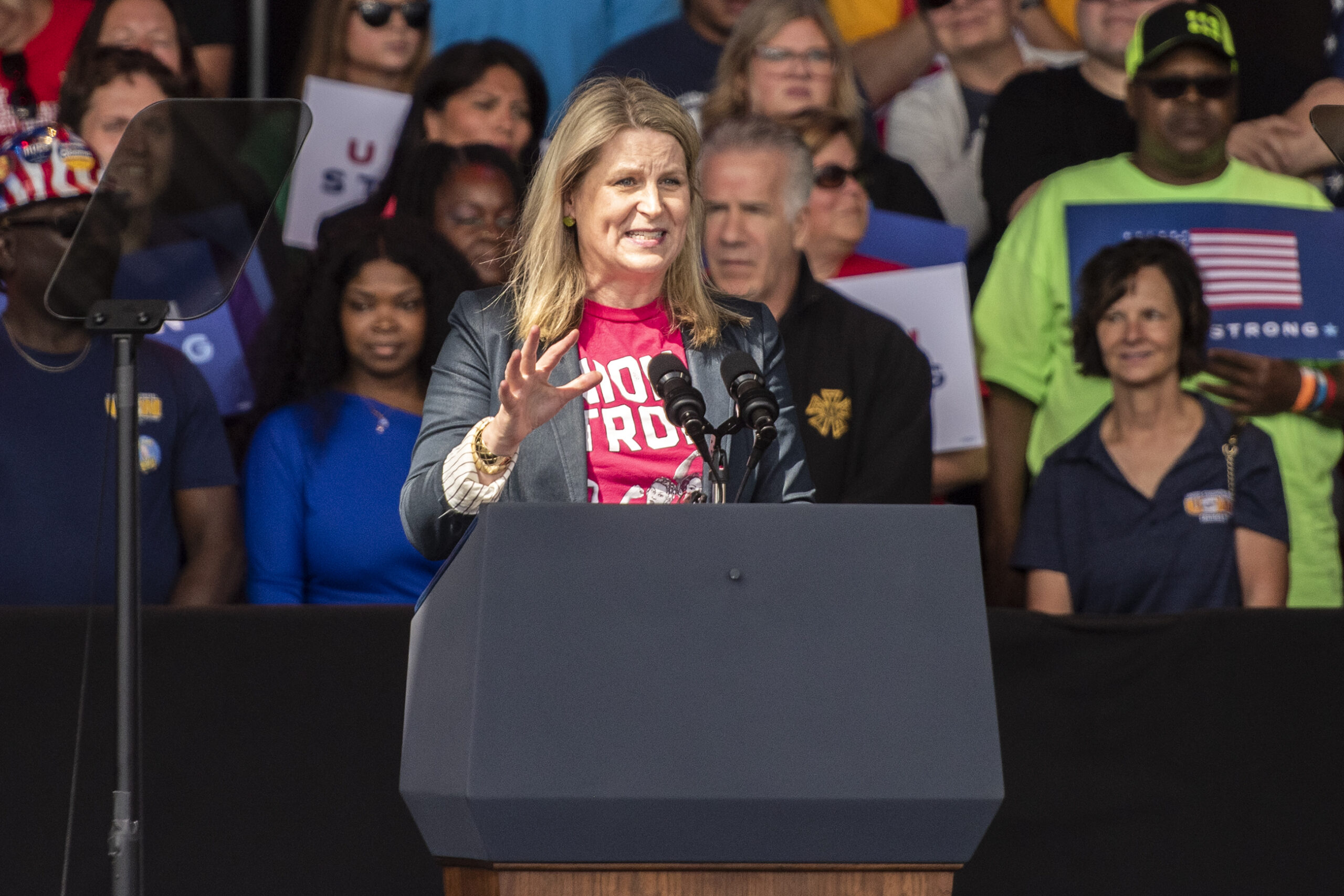 Elizabeth Shuler gestures as she speaks at a podium.