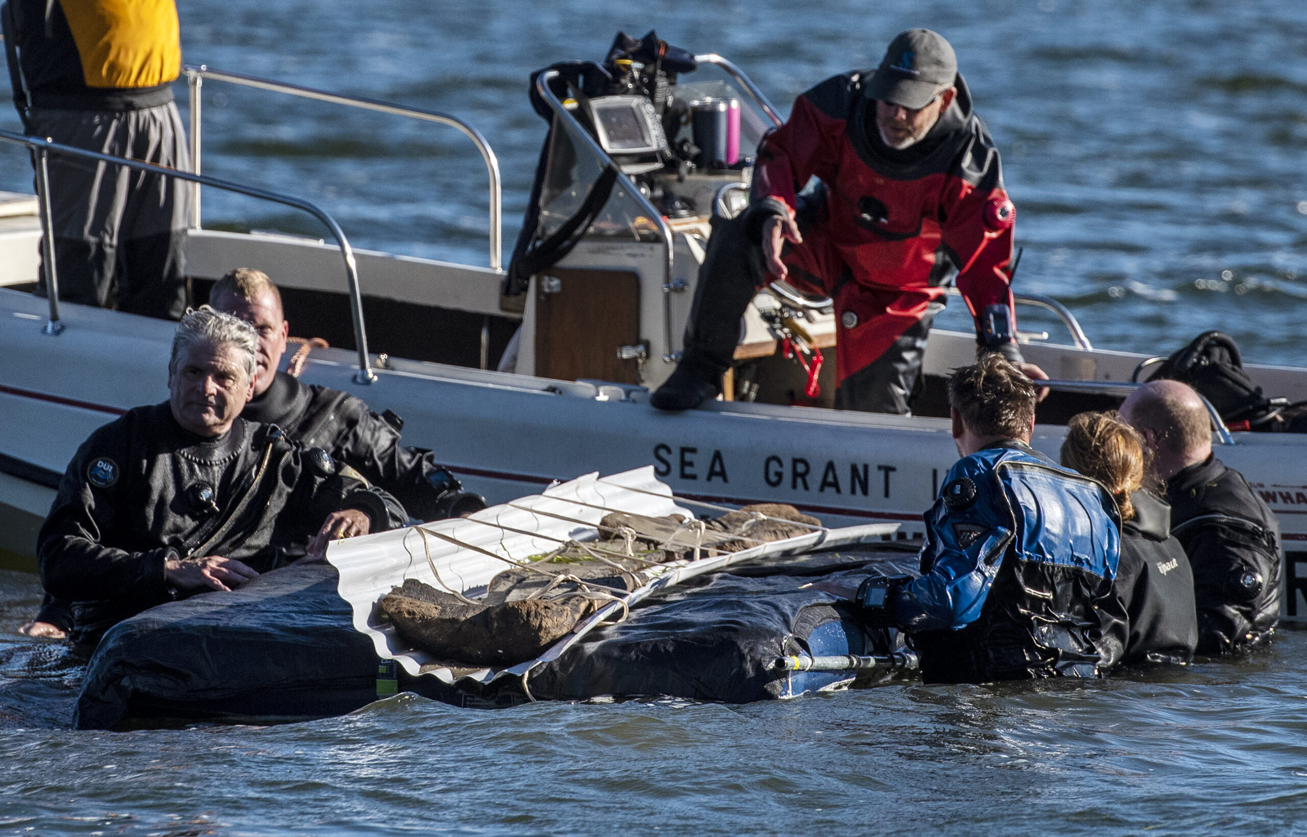 For 3,000 years old, it’s ‘looking really good’: Divers pull ancient canoe from Madison lake