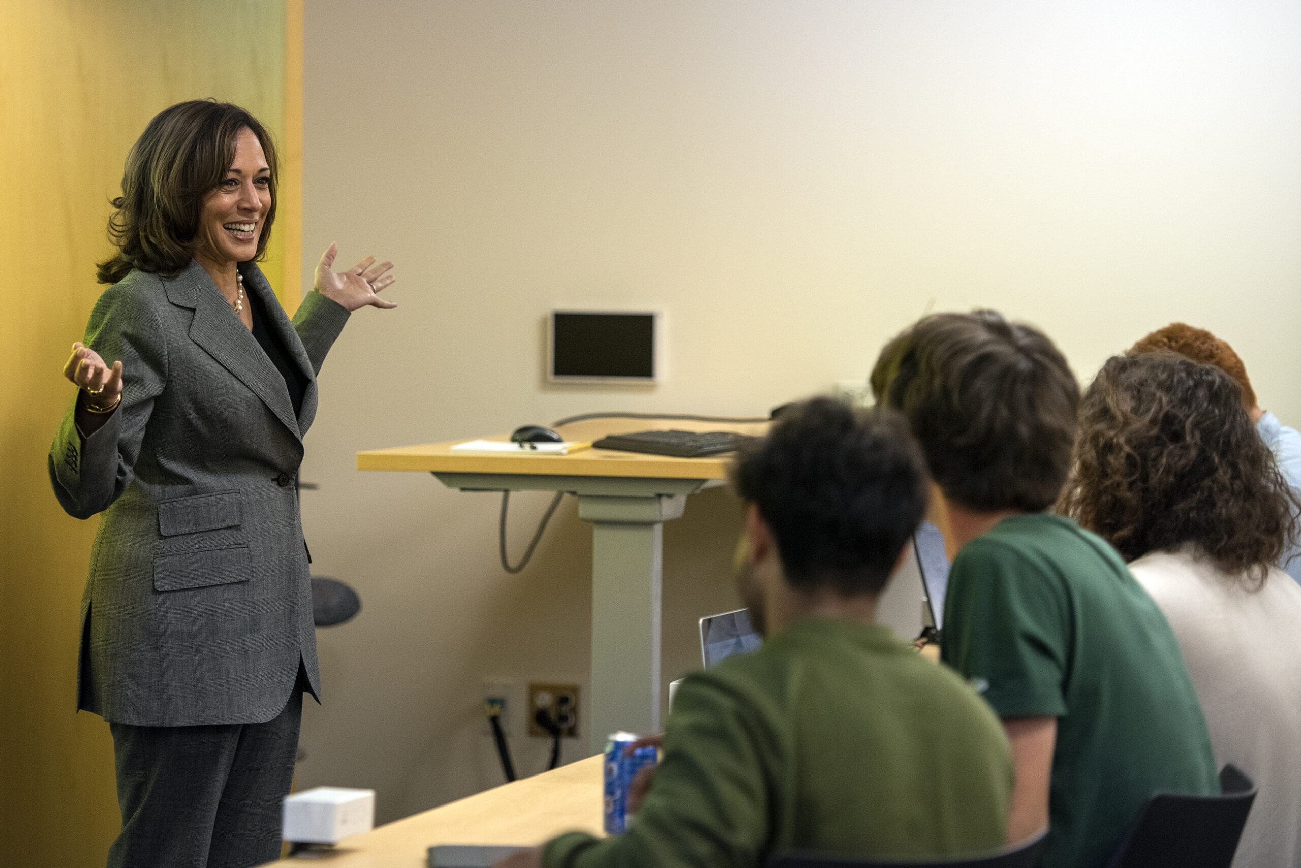 Vice President Kamala Harris gestures with her hands while speaking to students in a classroom.