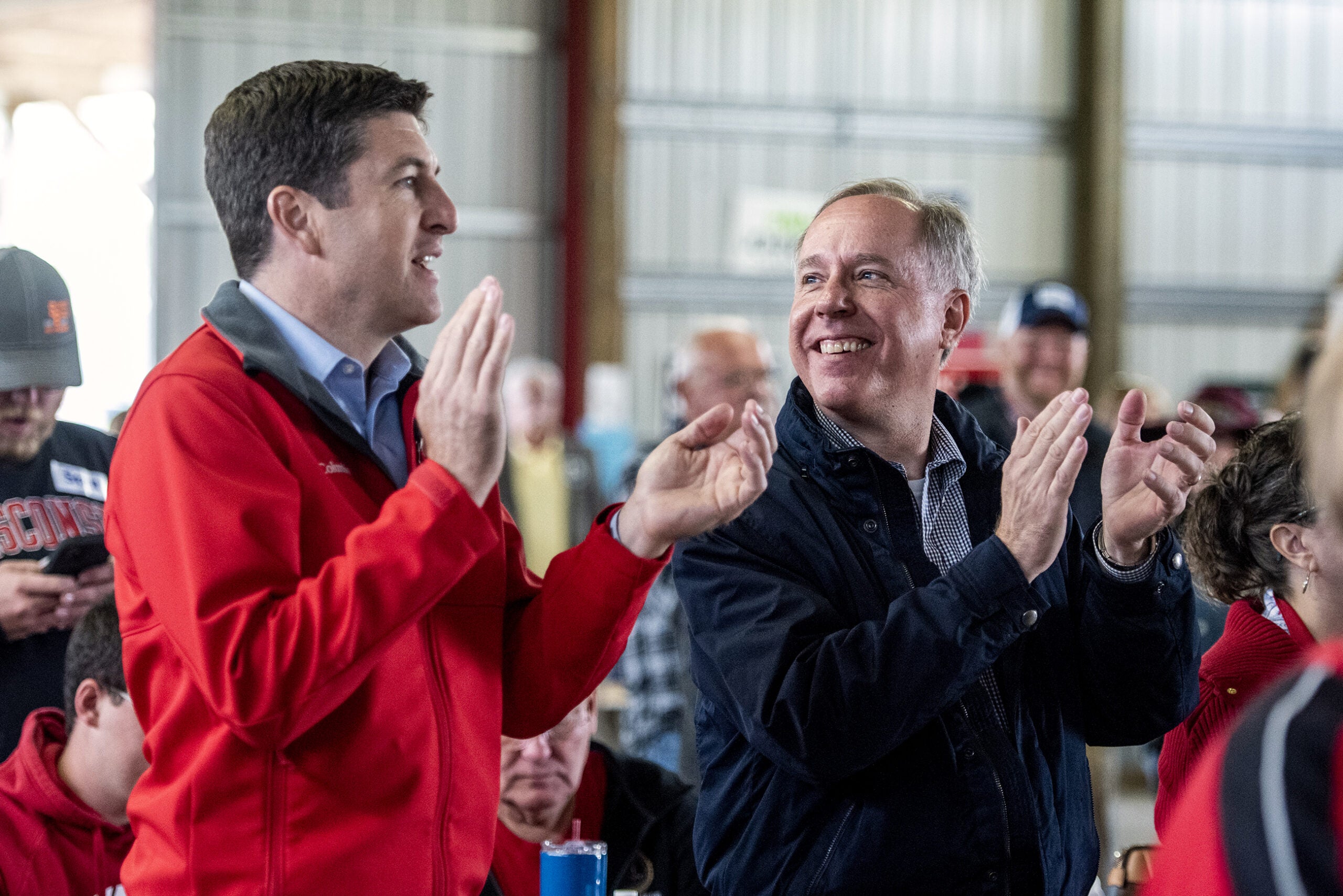 Assembly Speaker Robin Vos applauds and smiles at U.S. Rep. Bryan Steel as they stand in the crowd together.