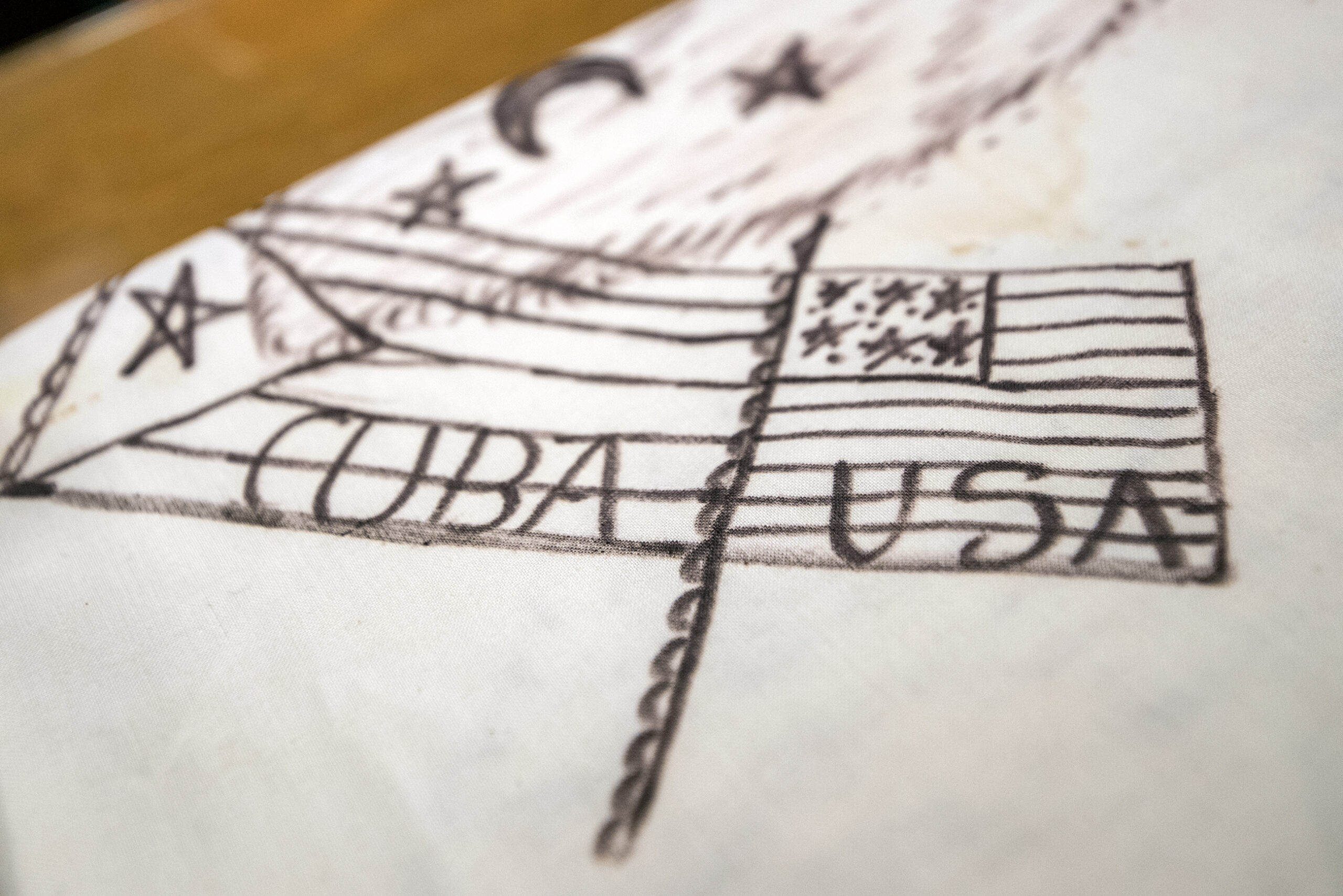 A cloth drawing of the U.S. and Cuba flags