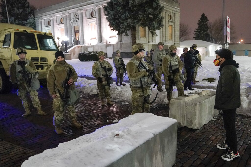 A protester confronts Wisconsin National Guard members on Jan. 5, 2021, in Kenosha, Wis.