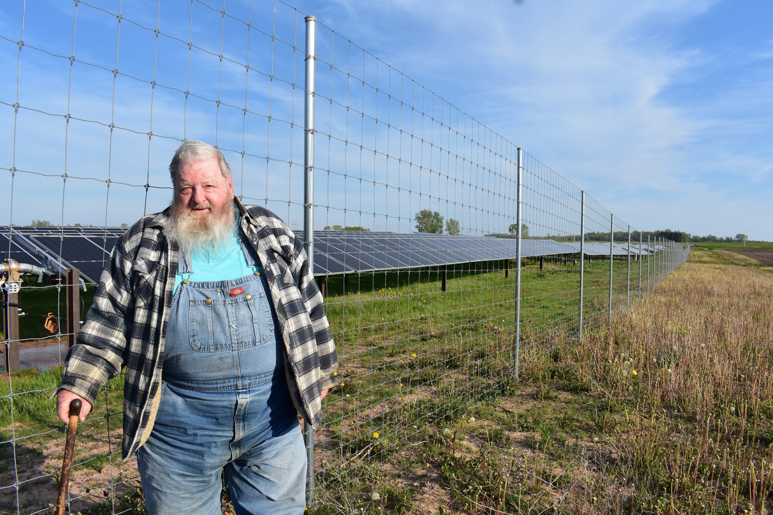 Retired dairy farmer Laddie Frank stands near an array of photovoltaic panels on his land in Two Creeks, Wisconsin