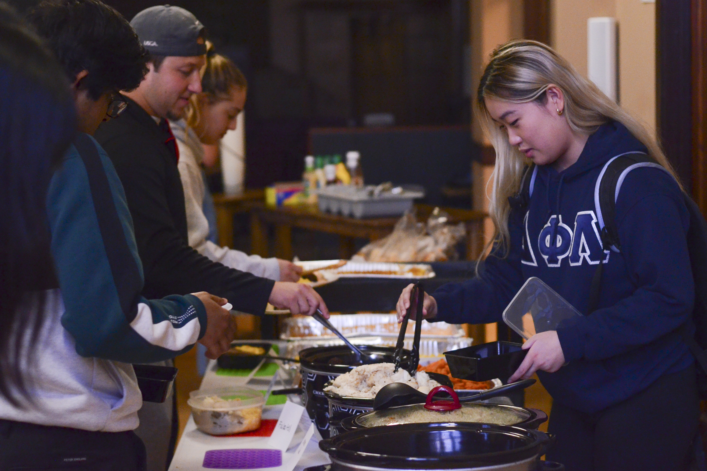 Attendees serve themselves from a buffet table at the Food Recovery Network’s Tuesday community meal