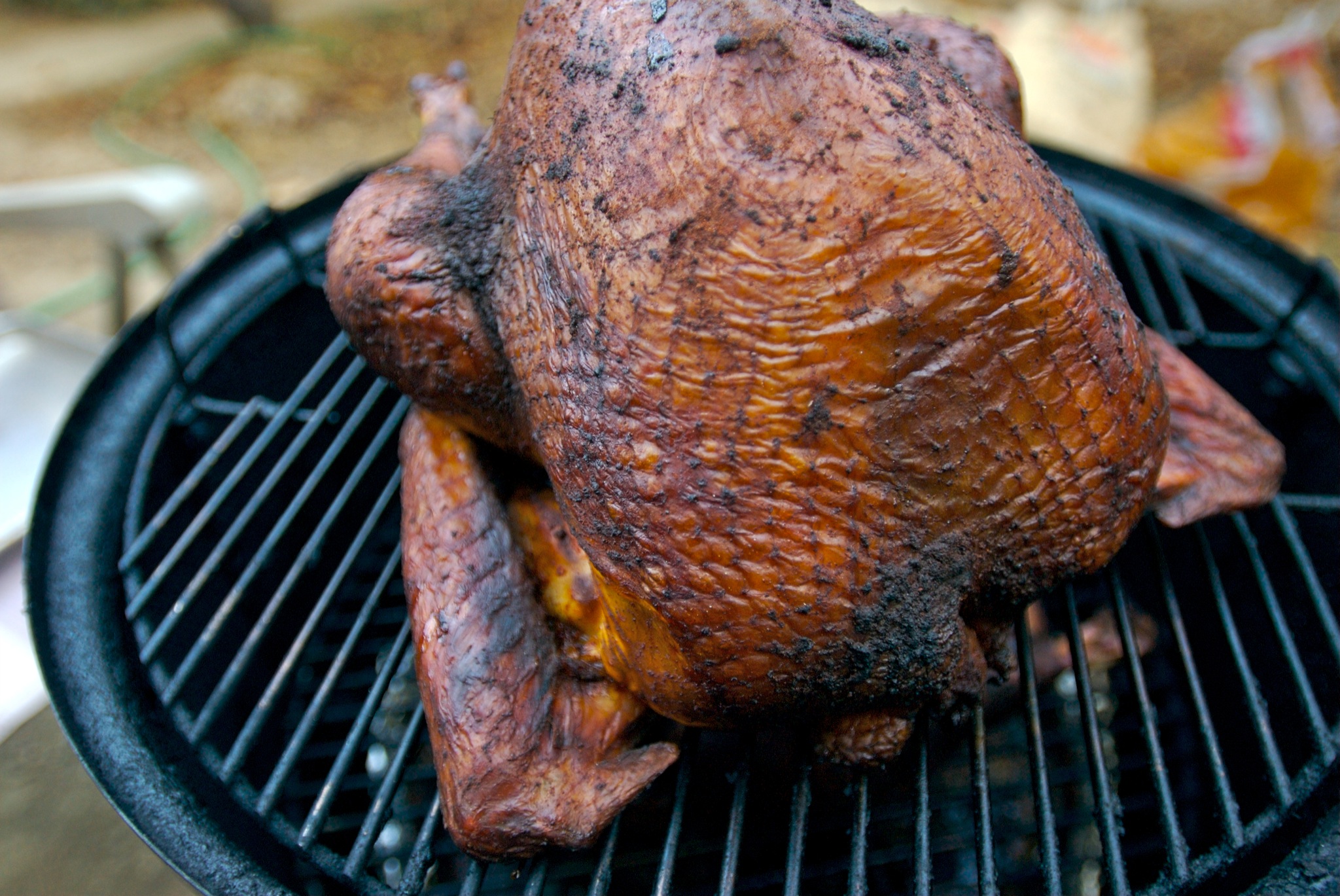 Turkey roasting on a barbeque grill.