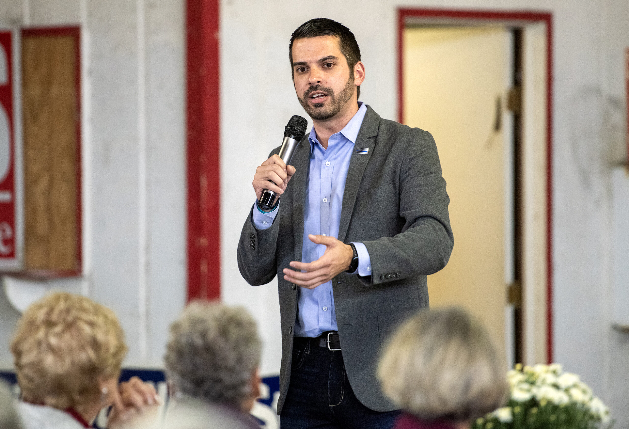 Eric Toney stands in front of an audience with a microphone during a Republican event.