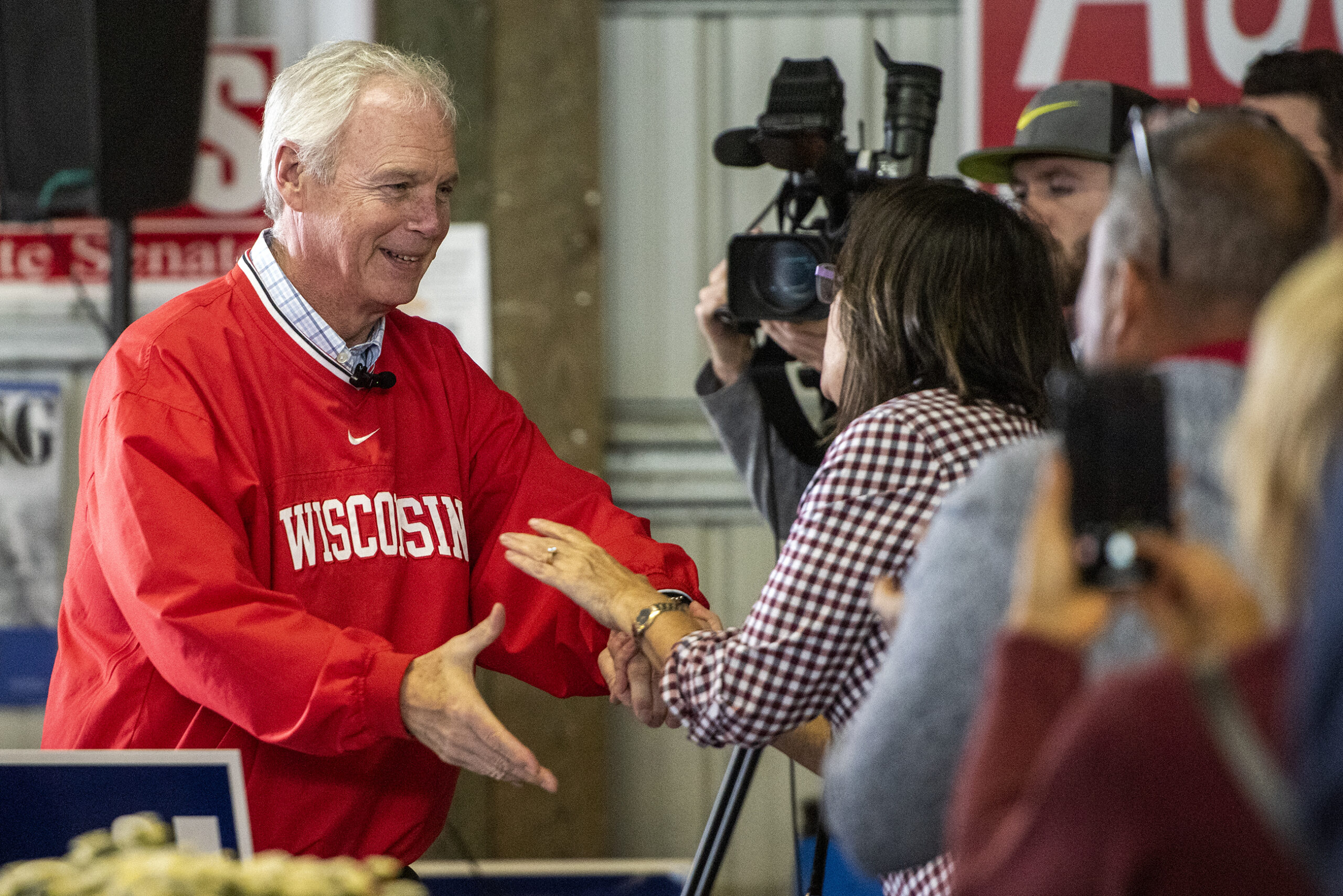 Sen. Ron Johnson reaches out and smiles as he greets supporters in attendance.