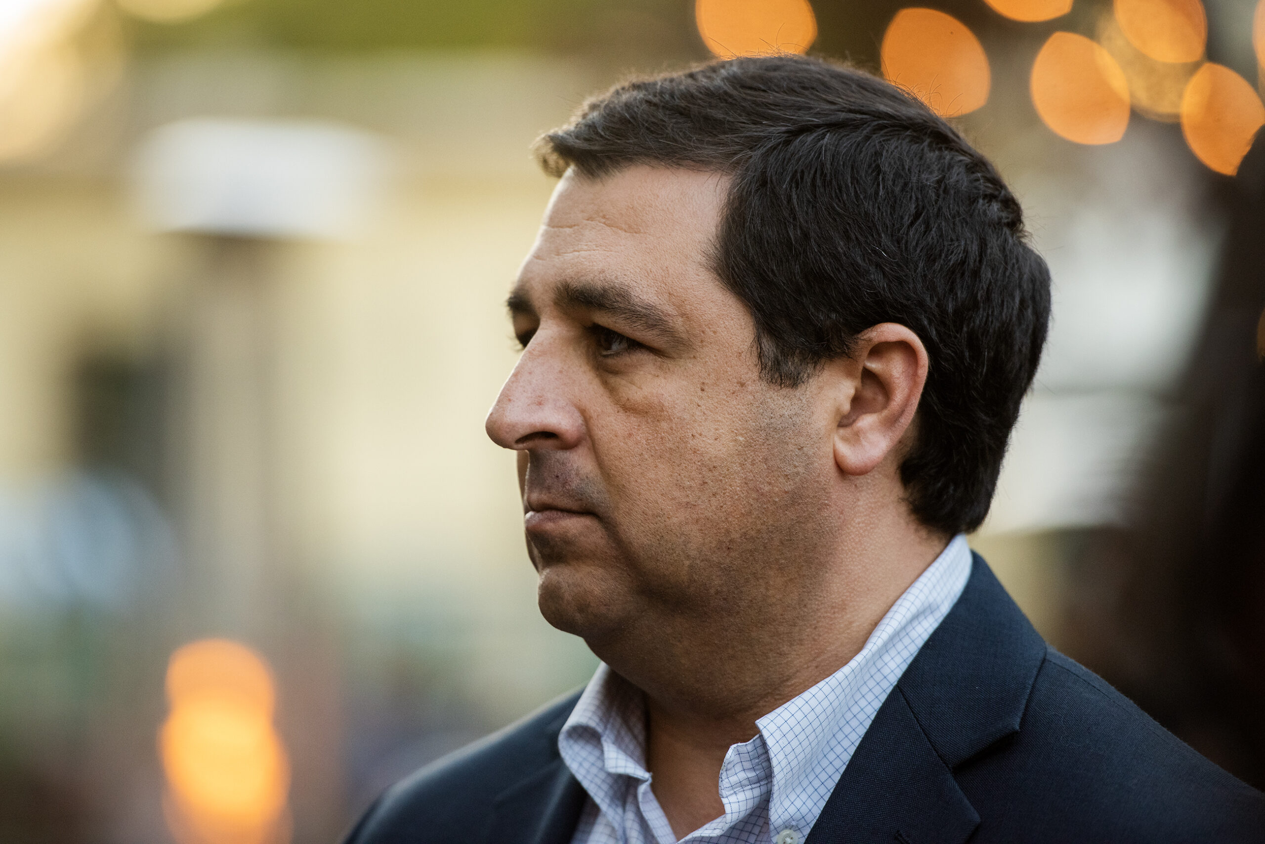 Attorney General Josh Kaul listens as a reporter asks questions.