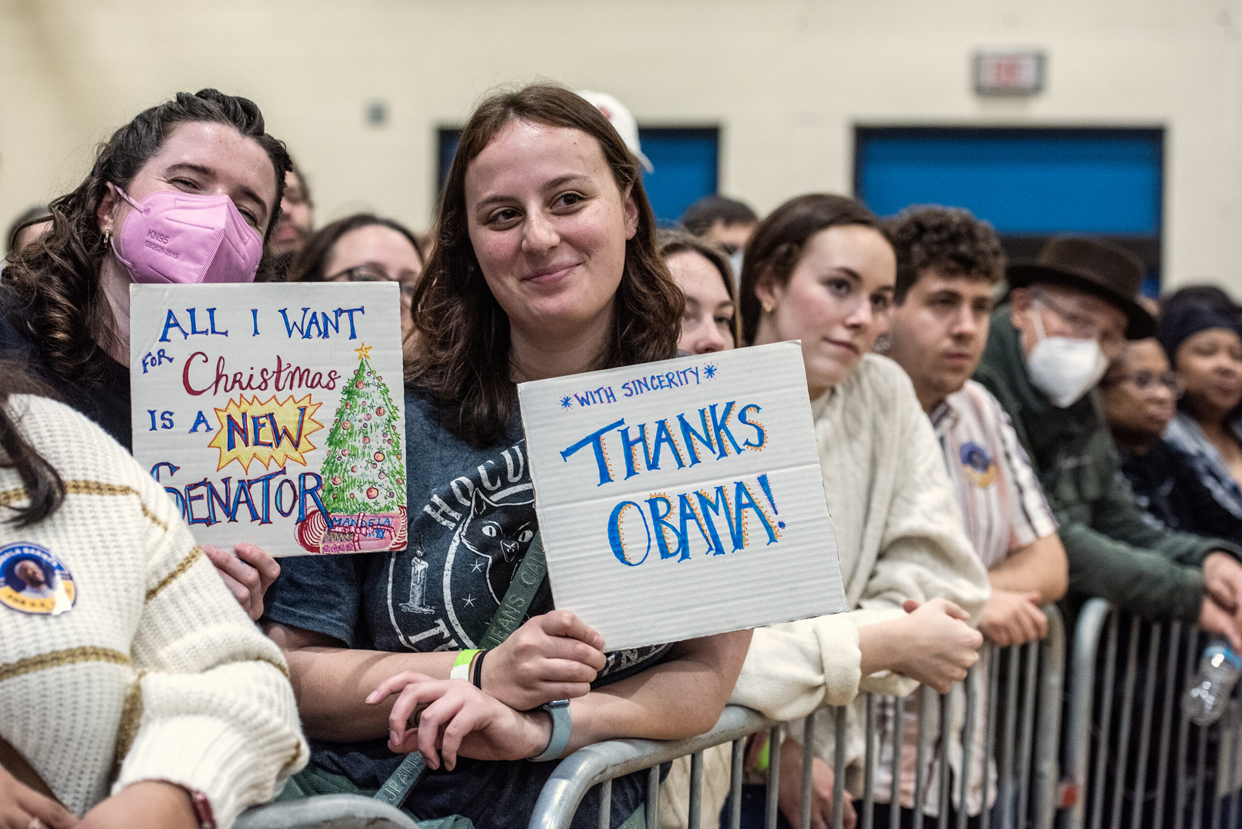 An attendee holds a sign that says 