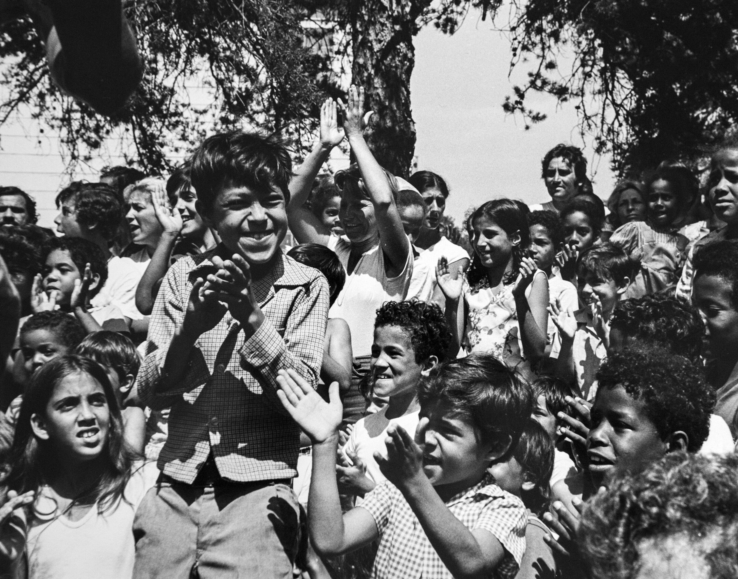 Cuban refugee children smiling and clapping
