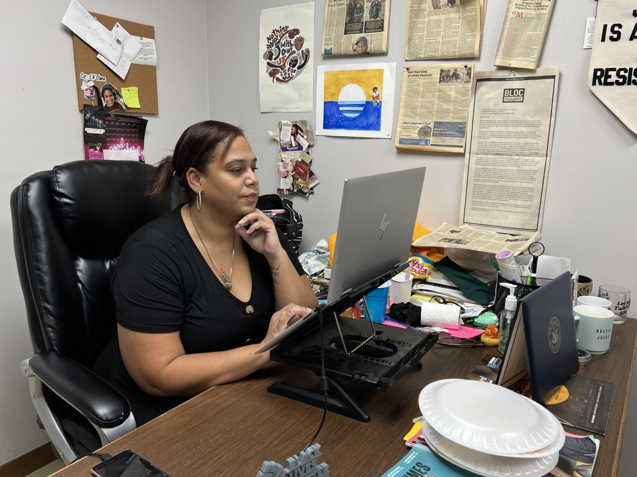 Angela Lang sits at her desk