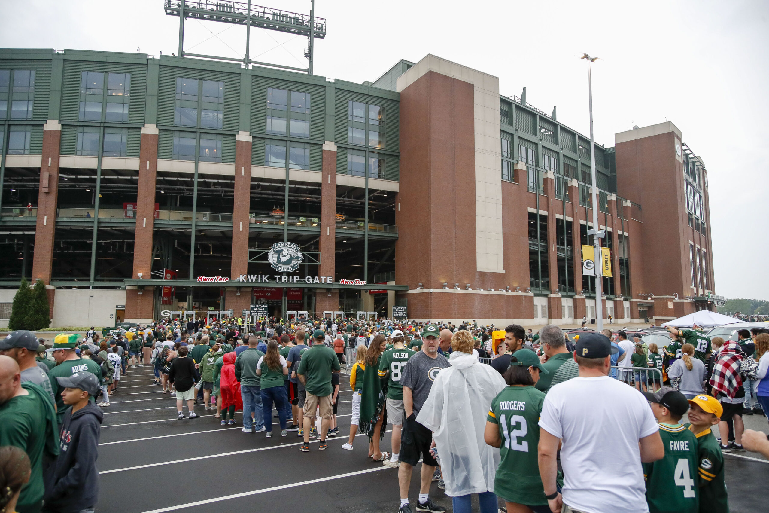 Green Bay Packers fans line up to enter Lambeau Field before training camp