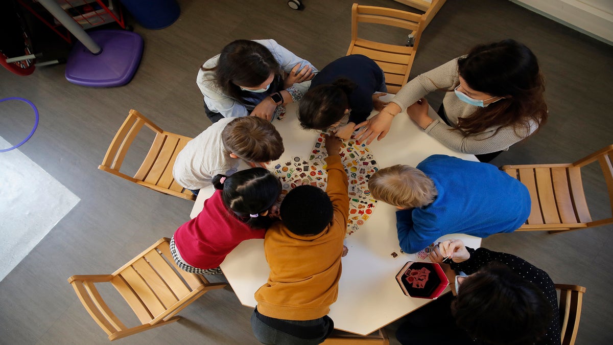 Children play with a therapist in the pediatric unit of Robert Debre hospital.