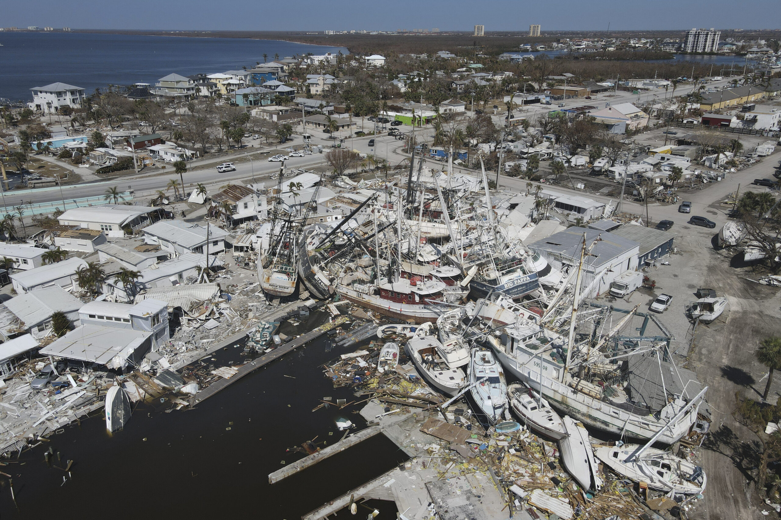 shrimp boats lie atop a hurricane-damaged mobile home park