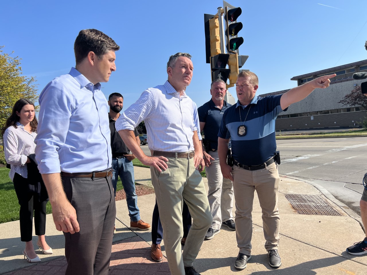 Tim Michels, accompanied by police officers, tours an area in Kenosha that was impacted by protests in 2020