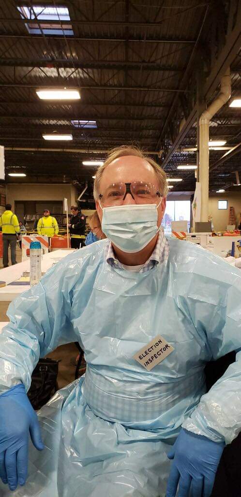 Robin Vos wearing protective gear as a volunteer poll worker