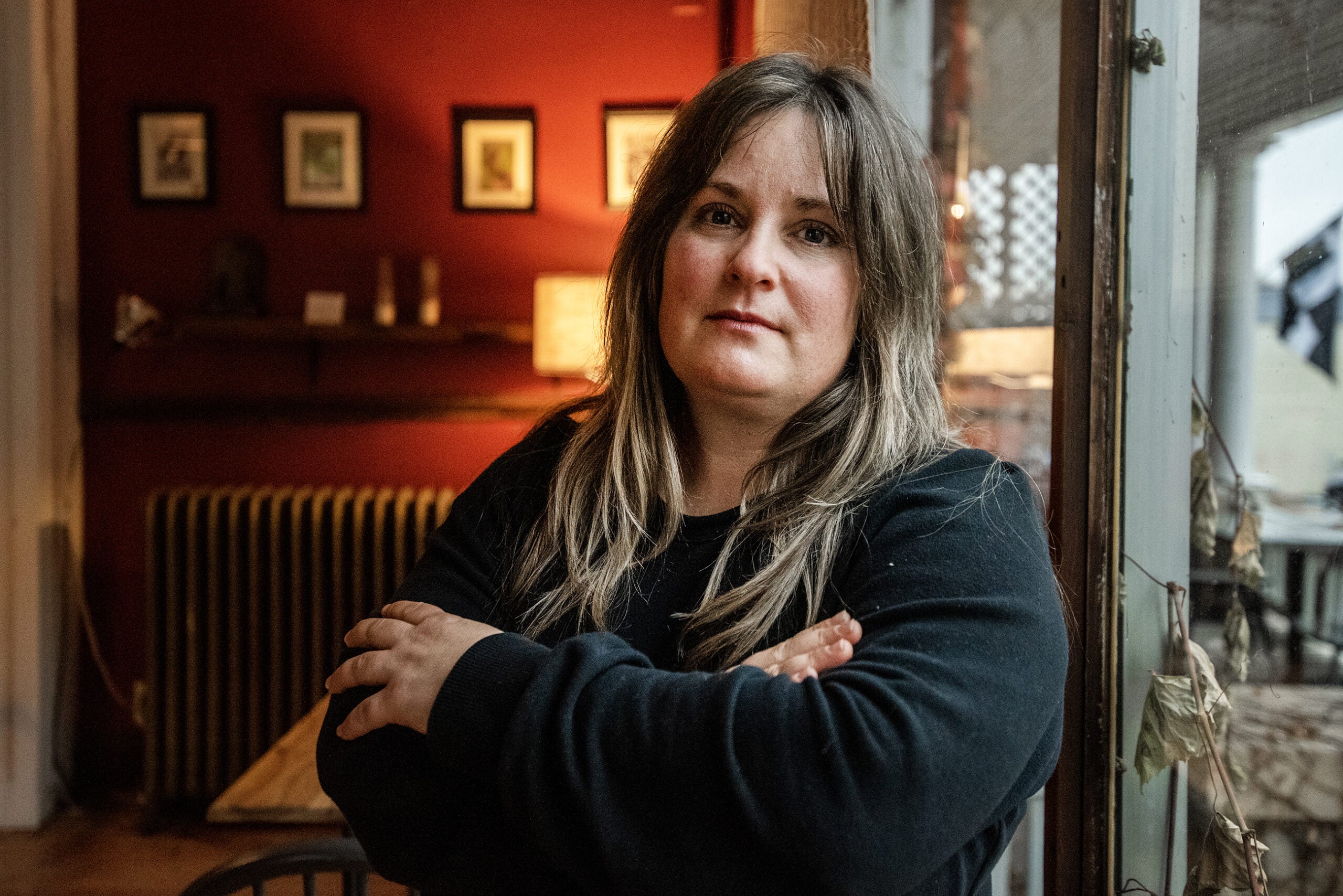 Christy Cole stands with her arms crossed.